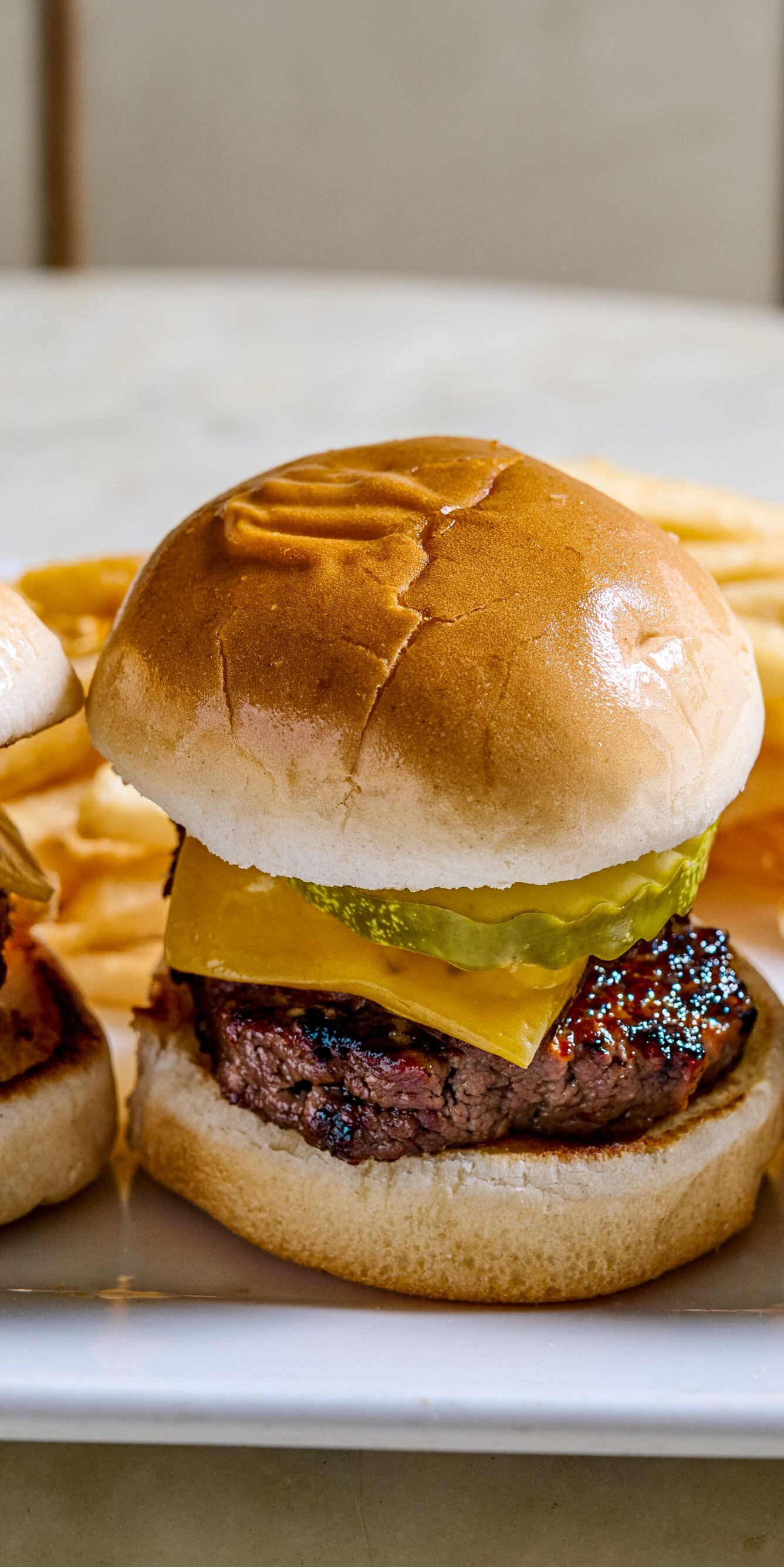 three burger sliders with fries