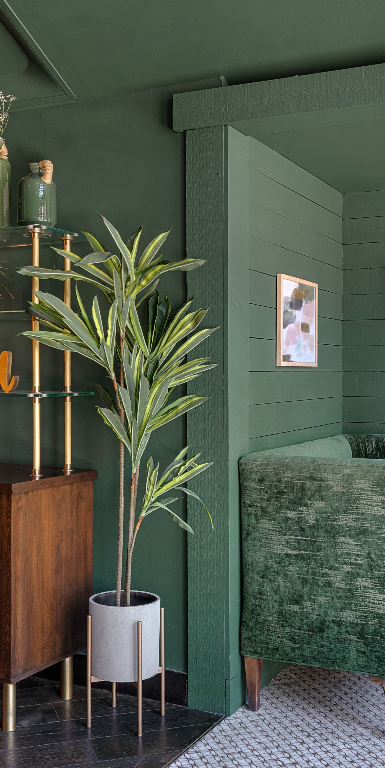 Private booth seating with green velvet chairs