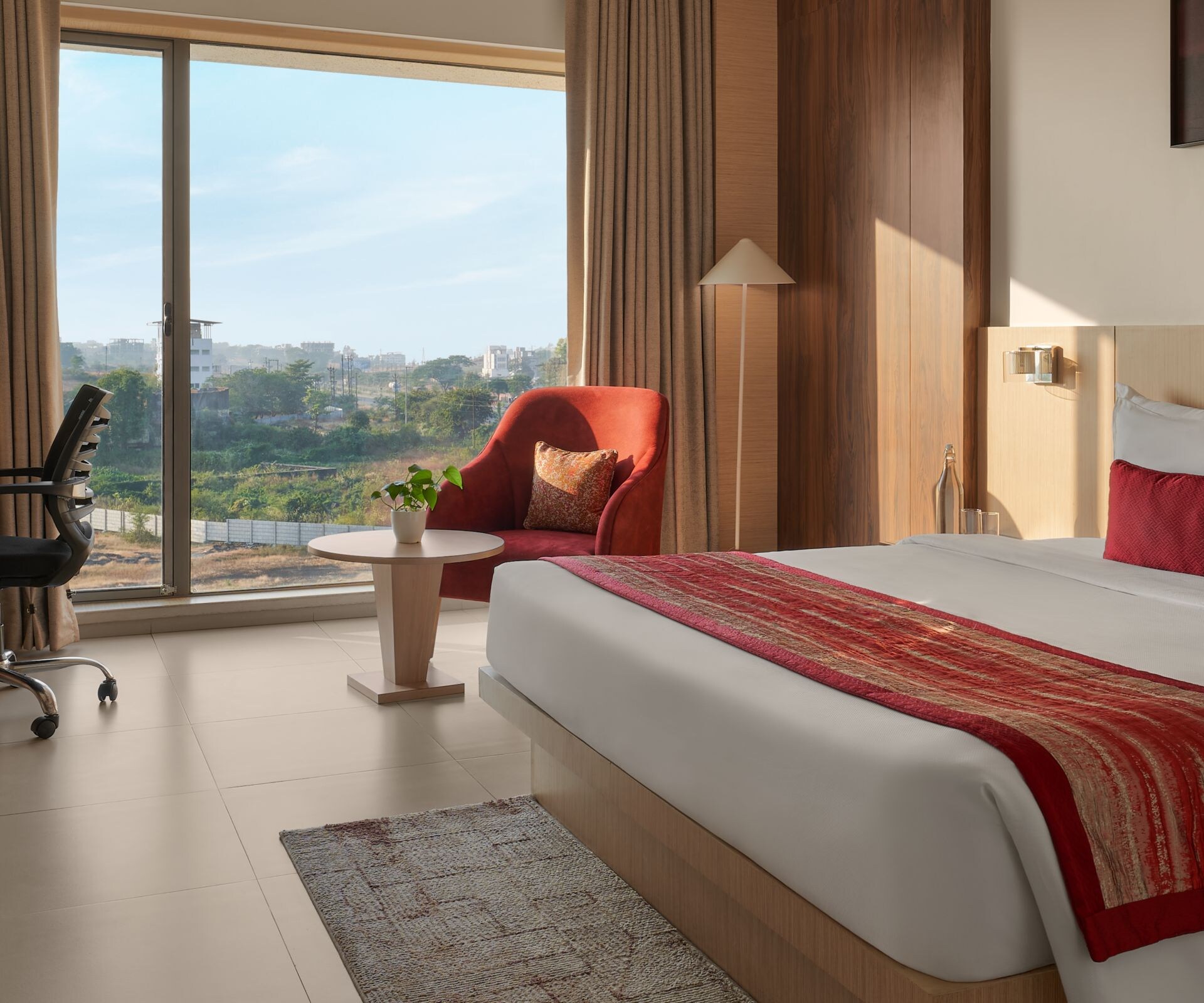 Guestroom with queen bed, desk and TV