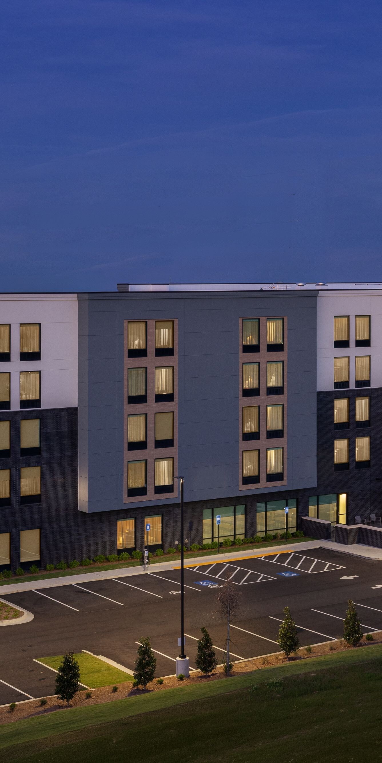 Hotel Exterior at night with parking lot
