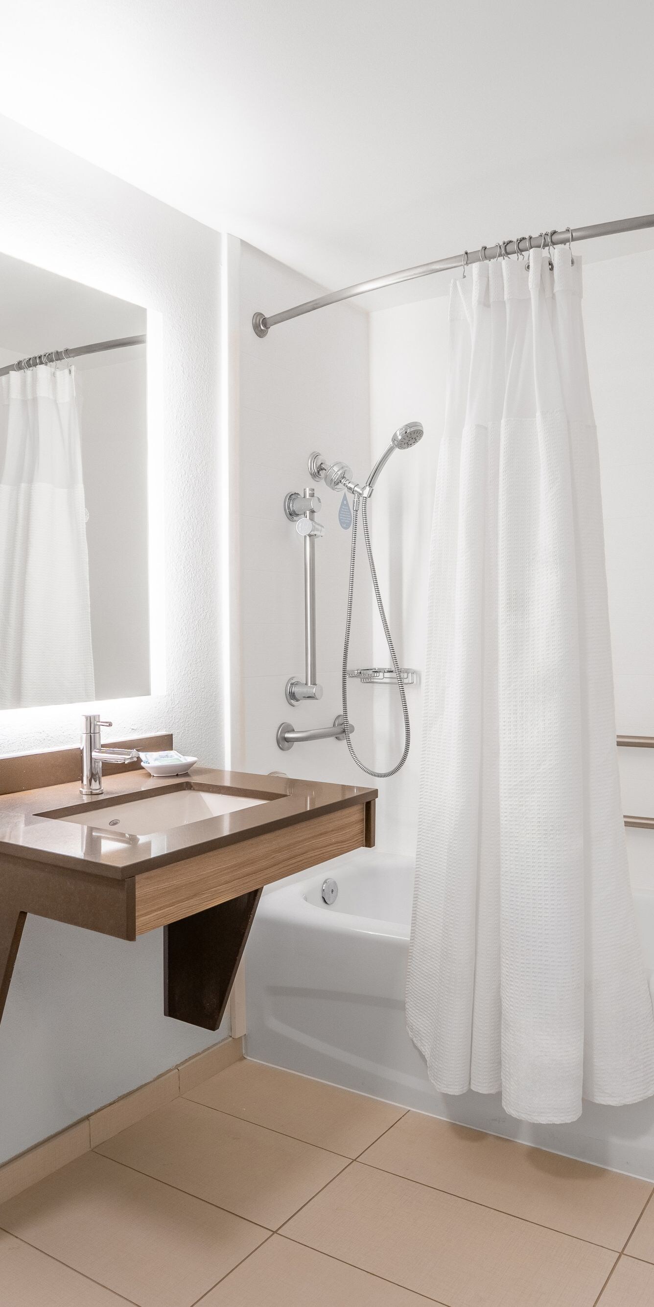 Accessible Shower/Tub Combo with bulk amenities.