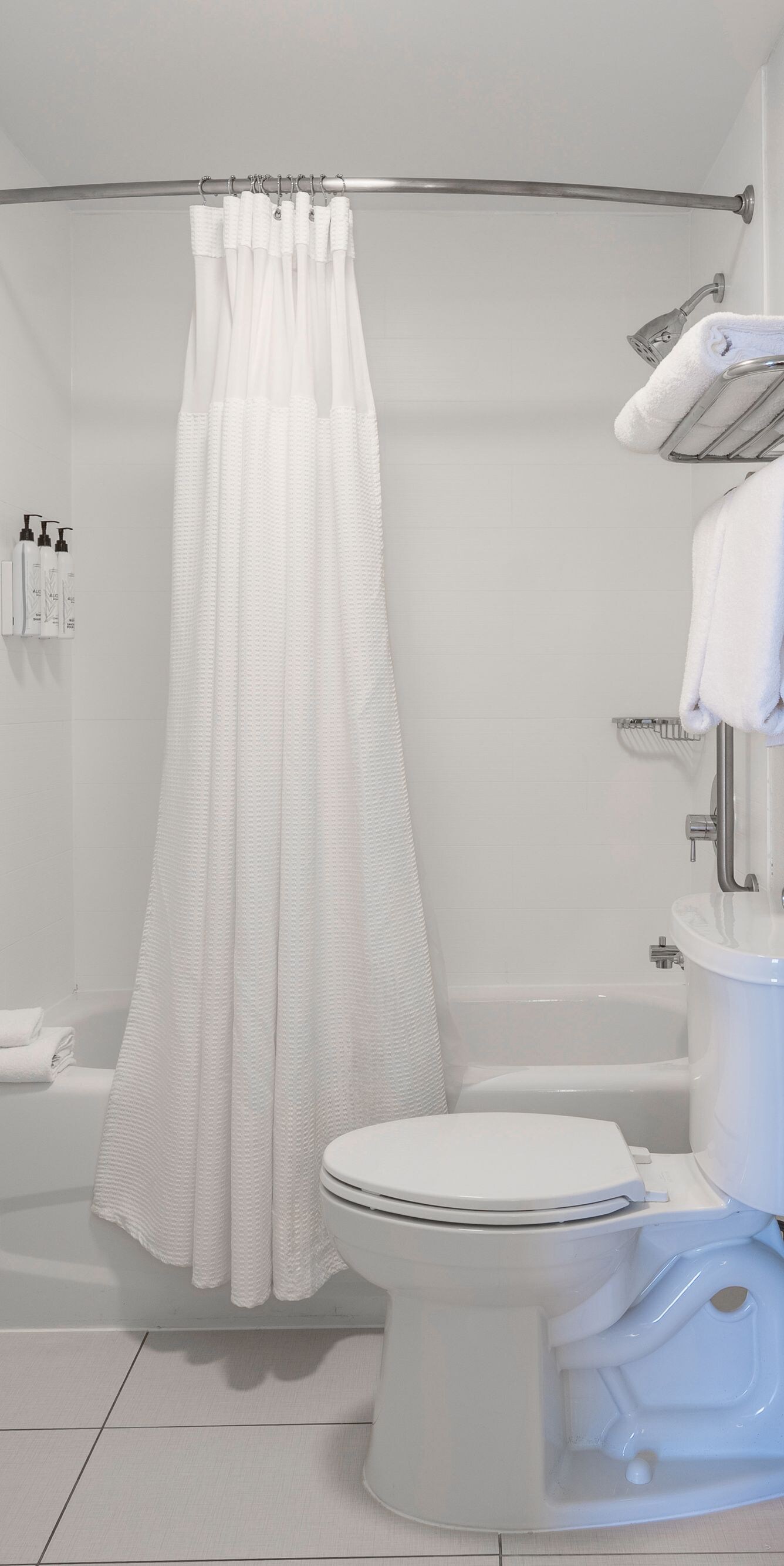 Shower/Tub combination with bulk shower amenities.