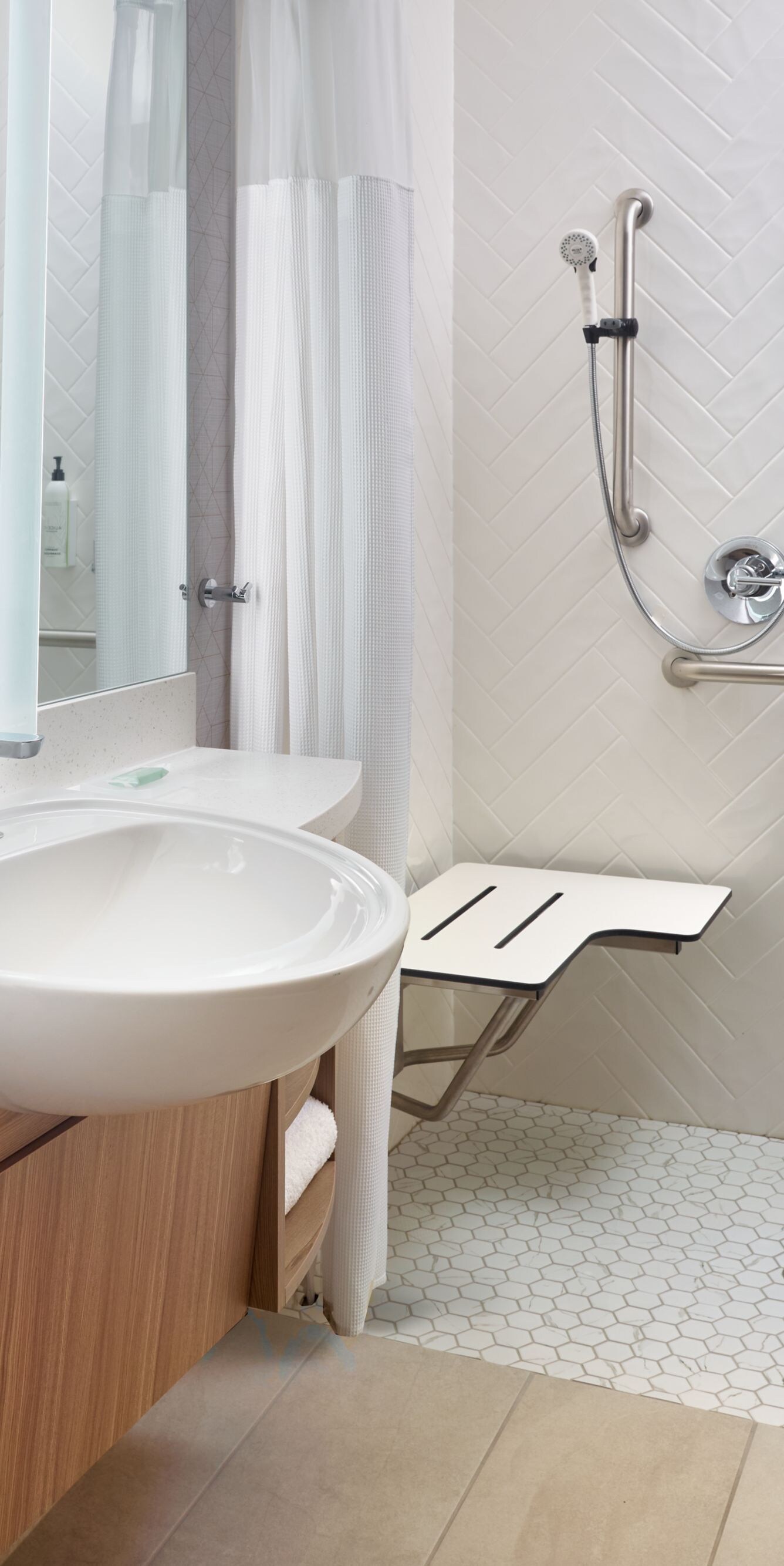 Accessible roll‑in shower with seat and grab bars