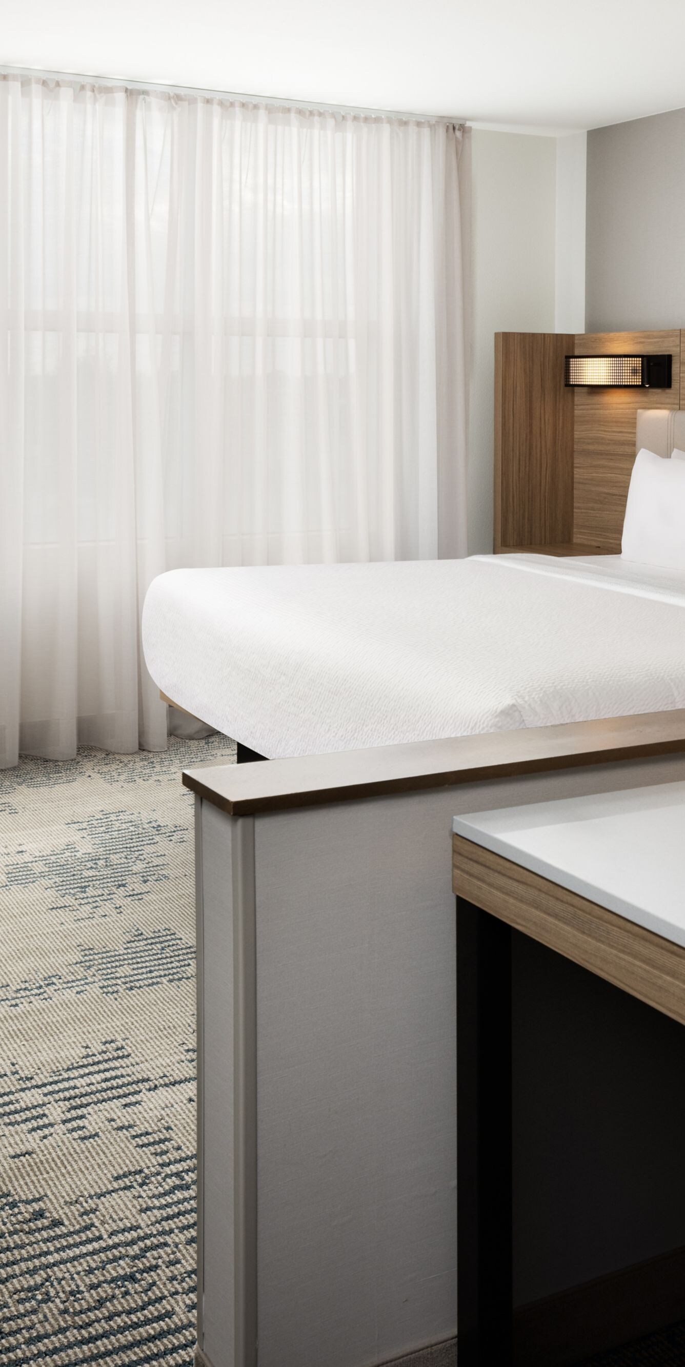 King guest room with desk and sheer drapes