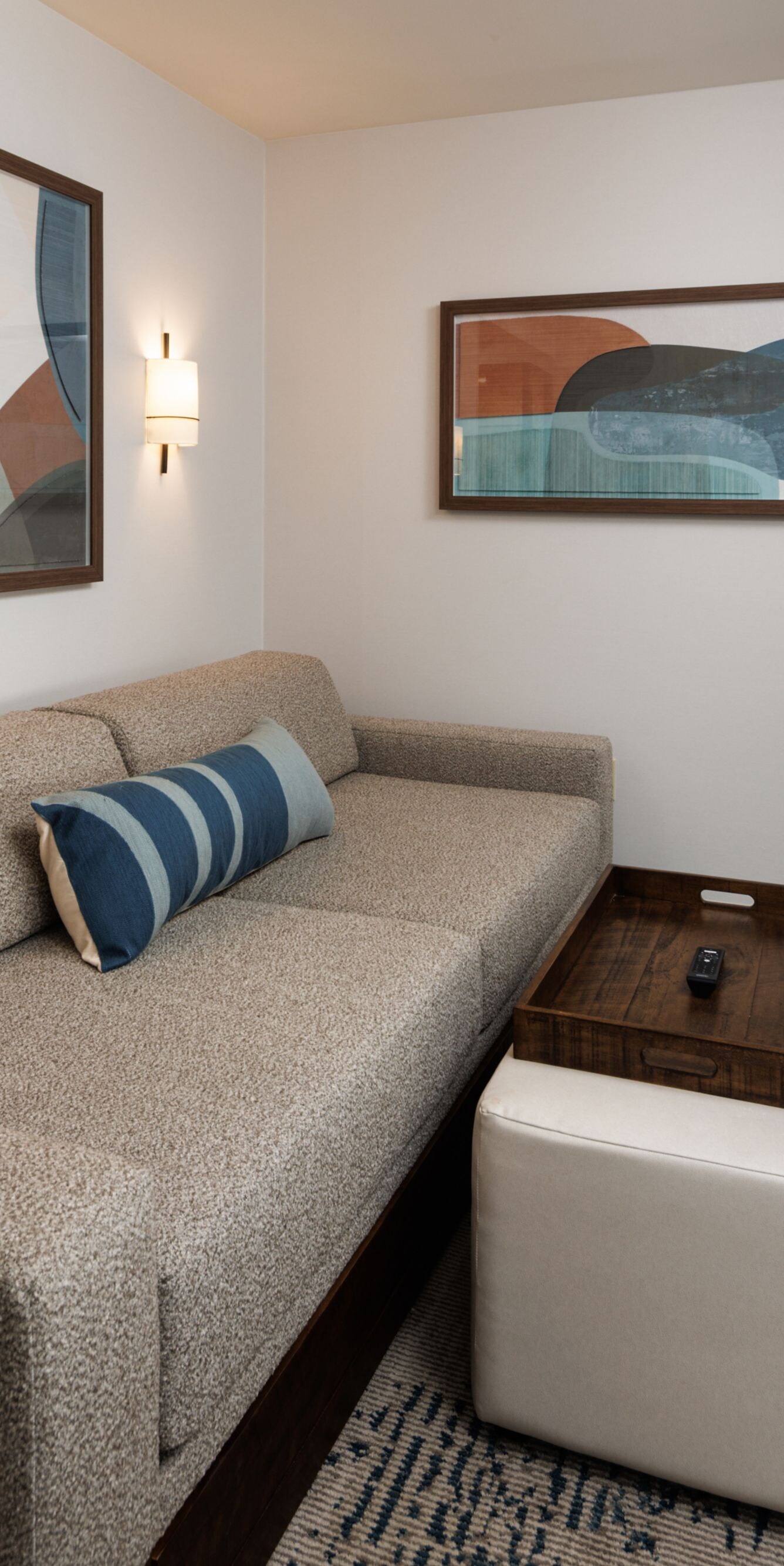 Suite living area with sofa and wall art