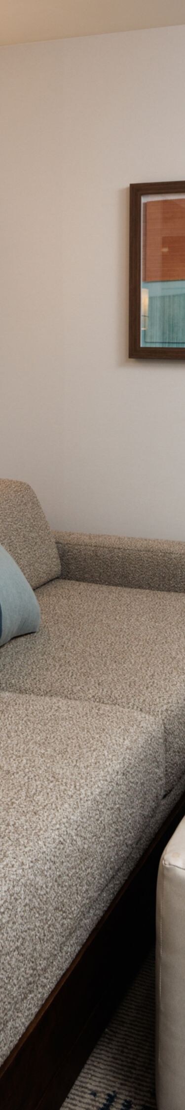 Suite living area with sofa and wall art