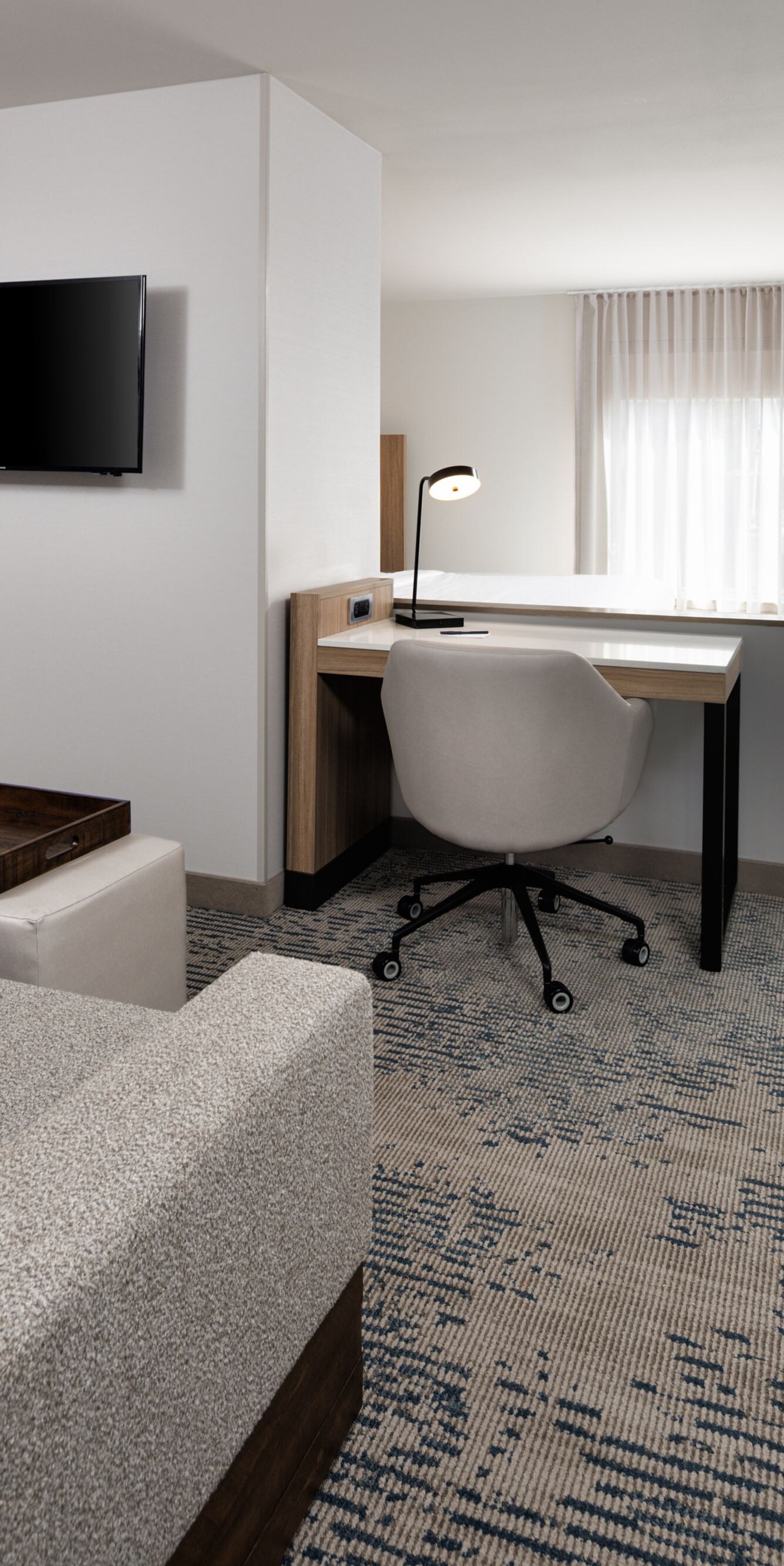 Suite with sofa, desk, and king bed