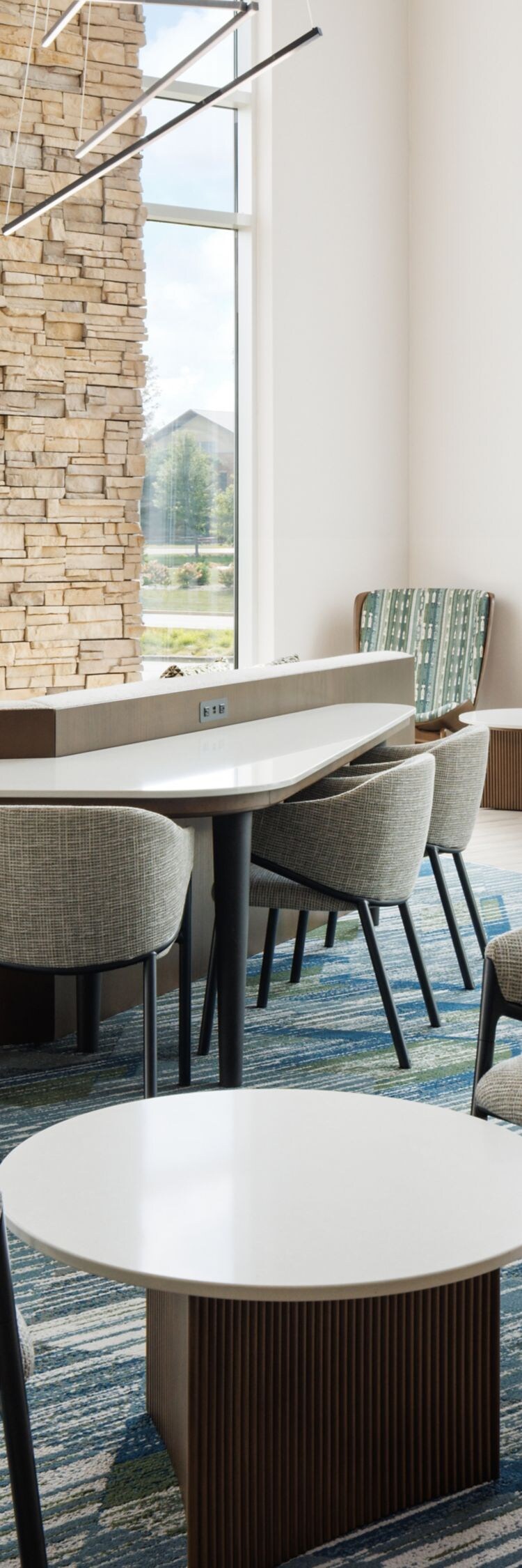 Lobby lounge with stone wall and seating
