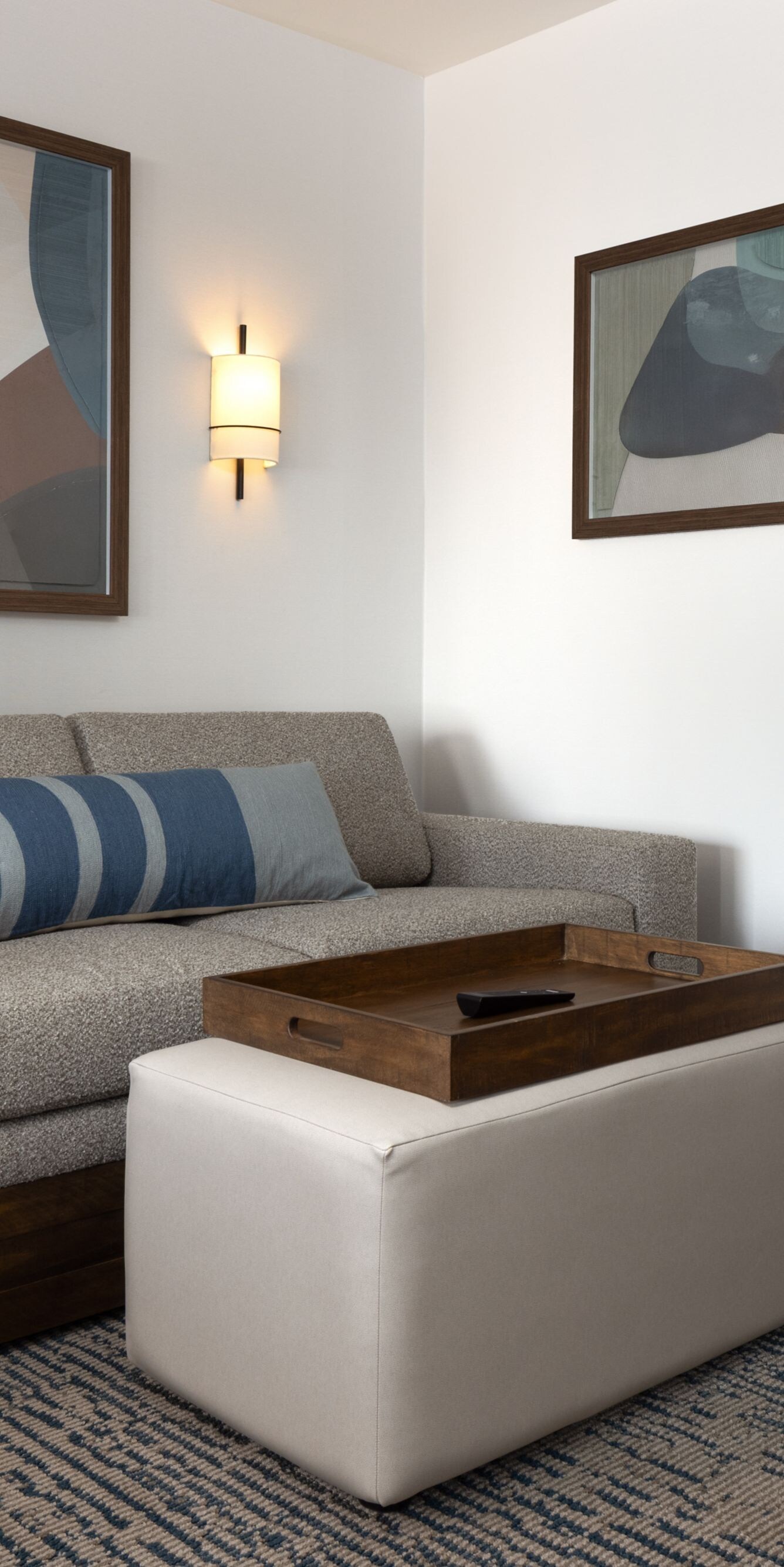 Guest room seating area with sofa and ottoman