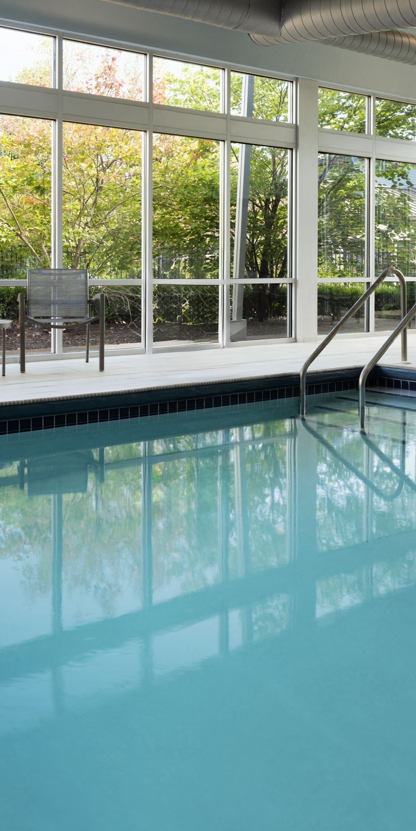 Indoor pool with floor-to-ceiling windows