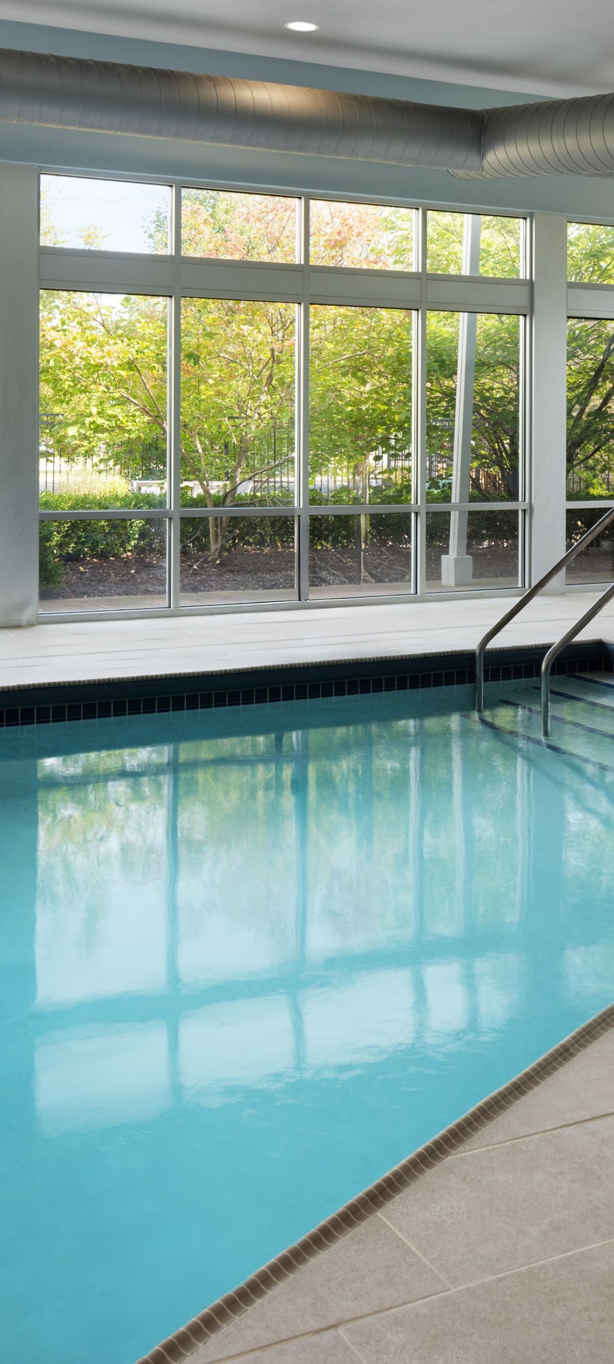 Indoor pool with floor-to-ceiling windows