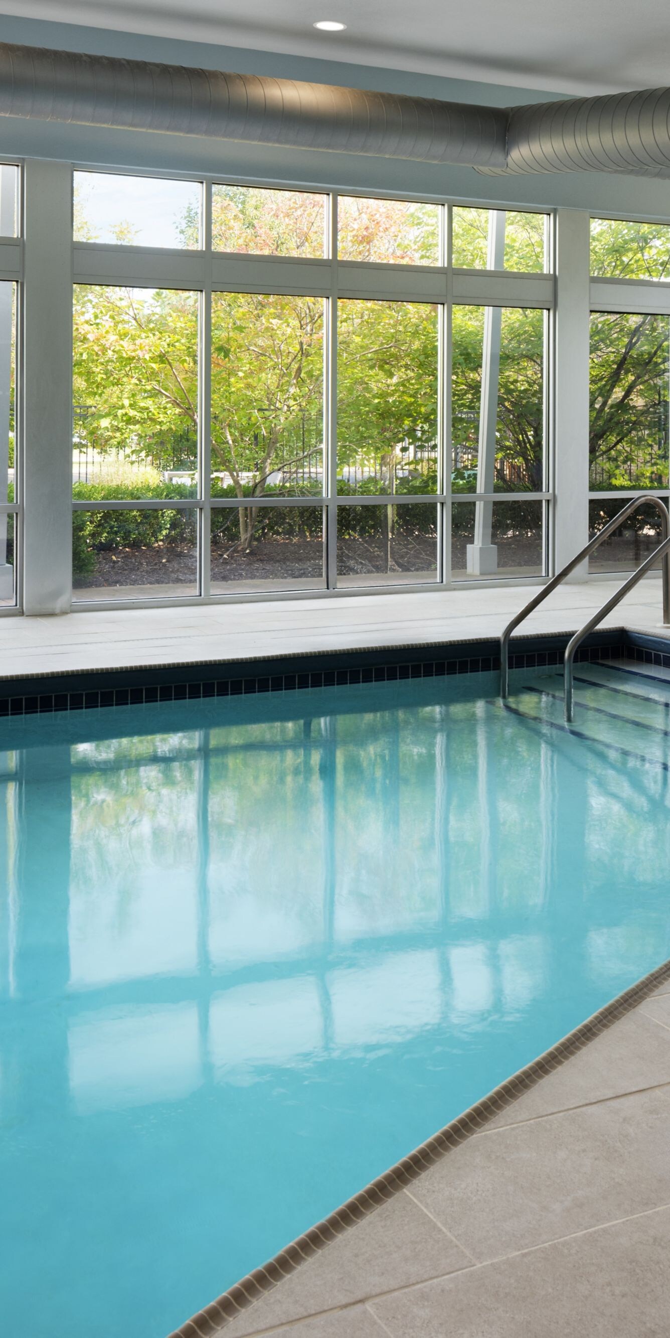 Indoor pool with floor-to-ceiling windows