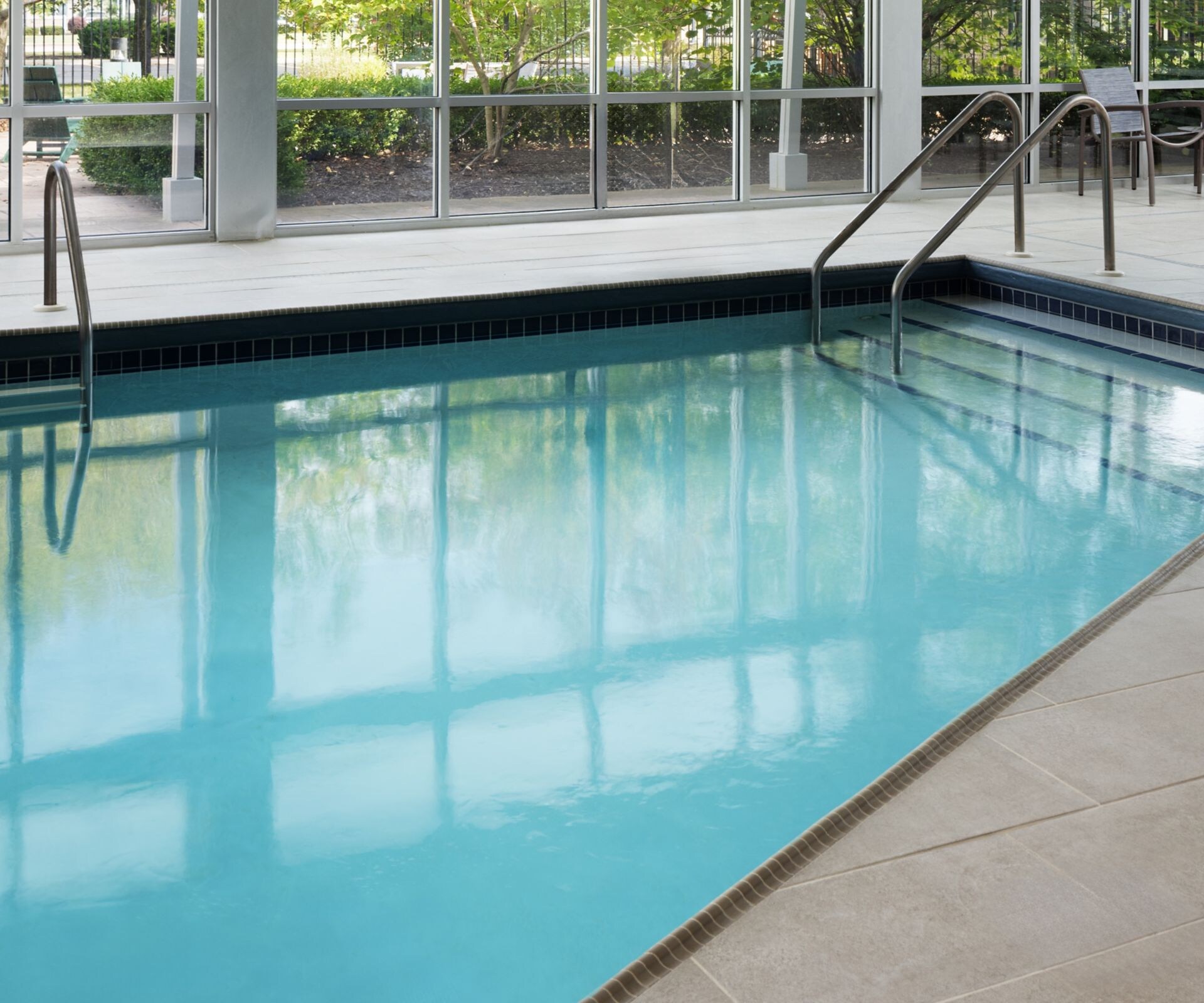 Indoor pool with floor-to-ceiling windows