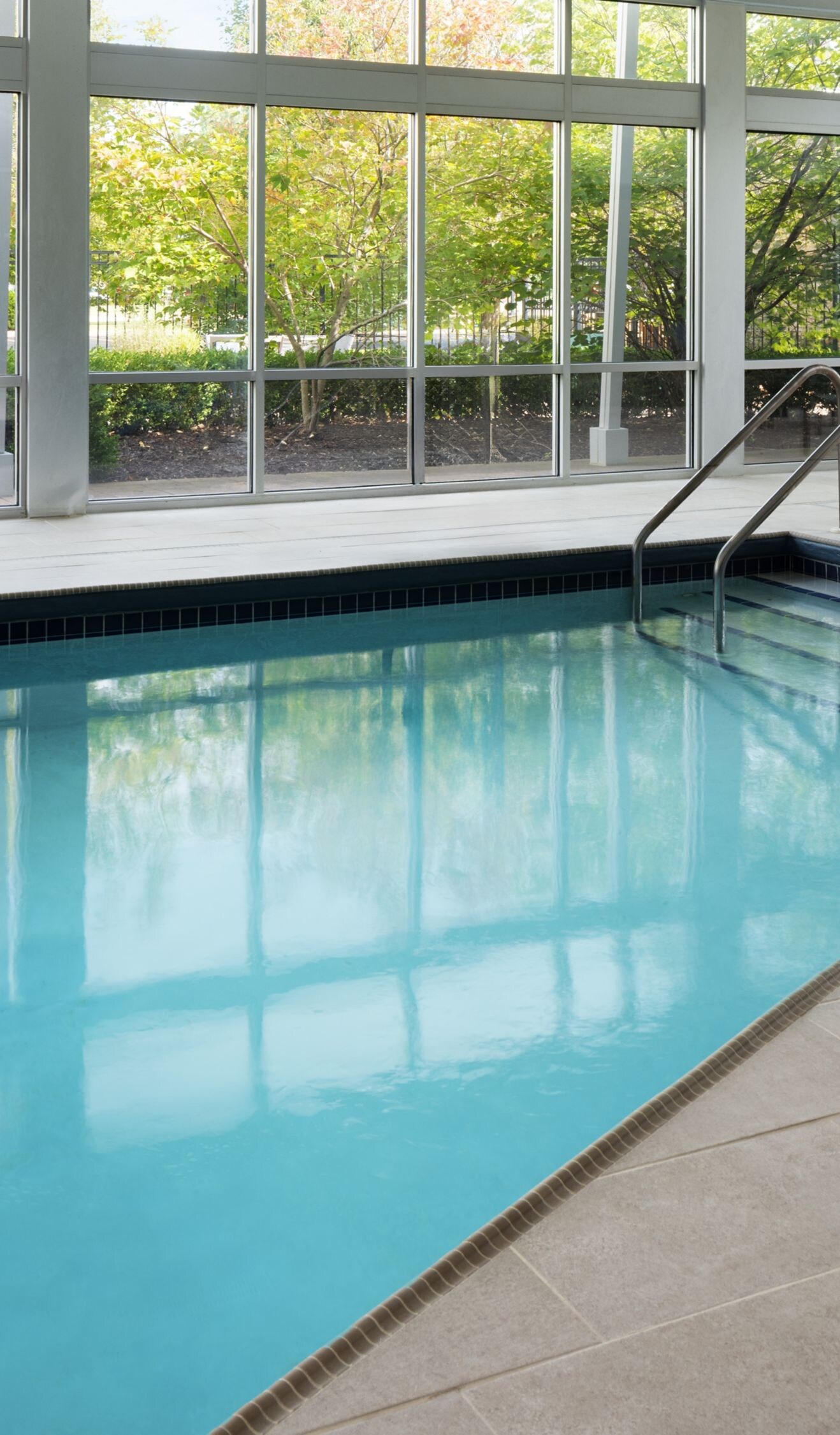 Indoor pool with floor-to-ceiling windows