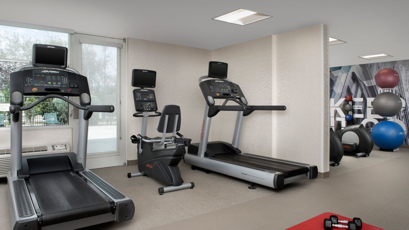 workout area with treadmill and recumbent bike