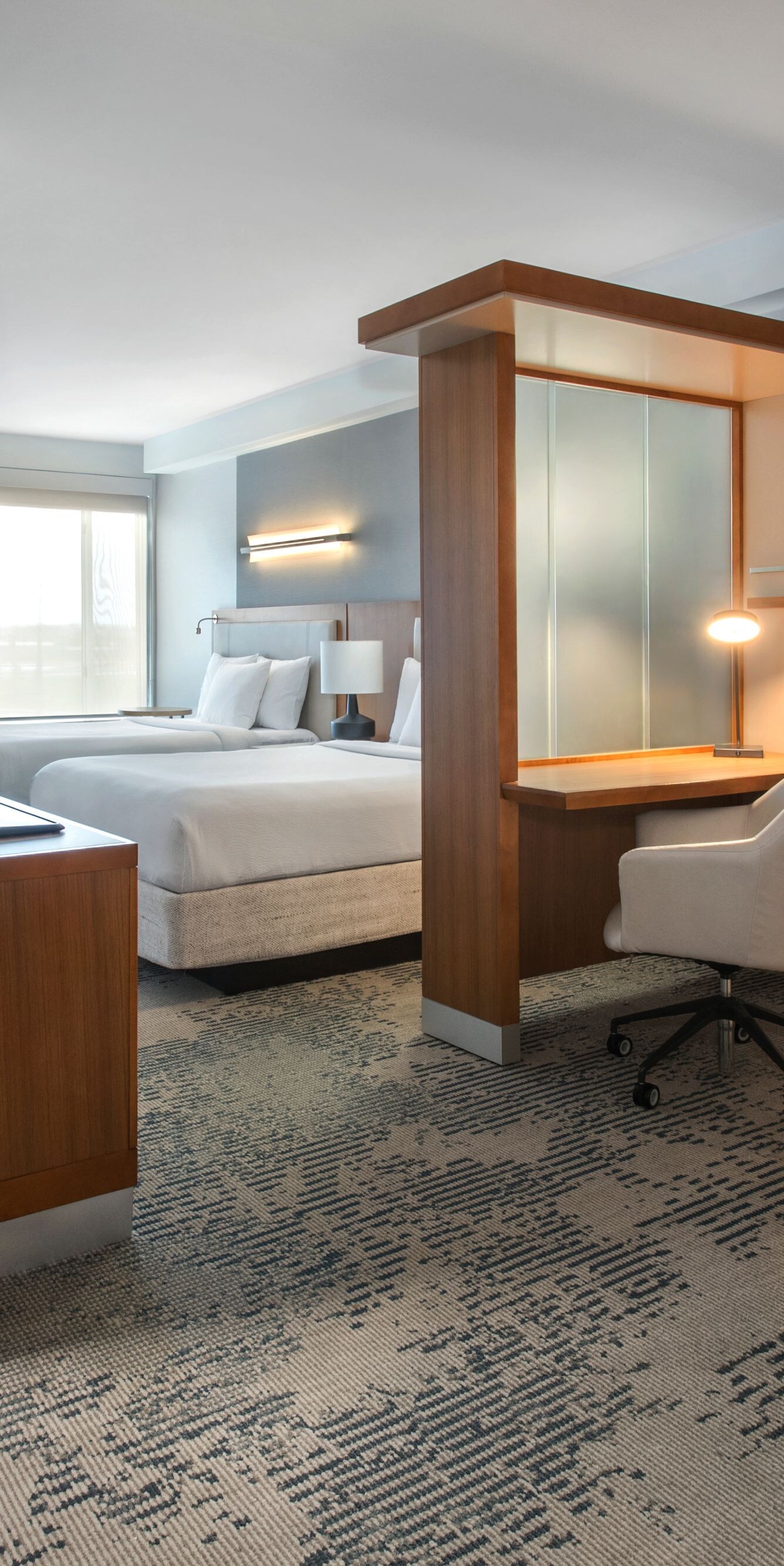 Modern guest room with desk and bed