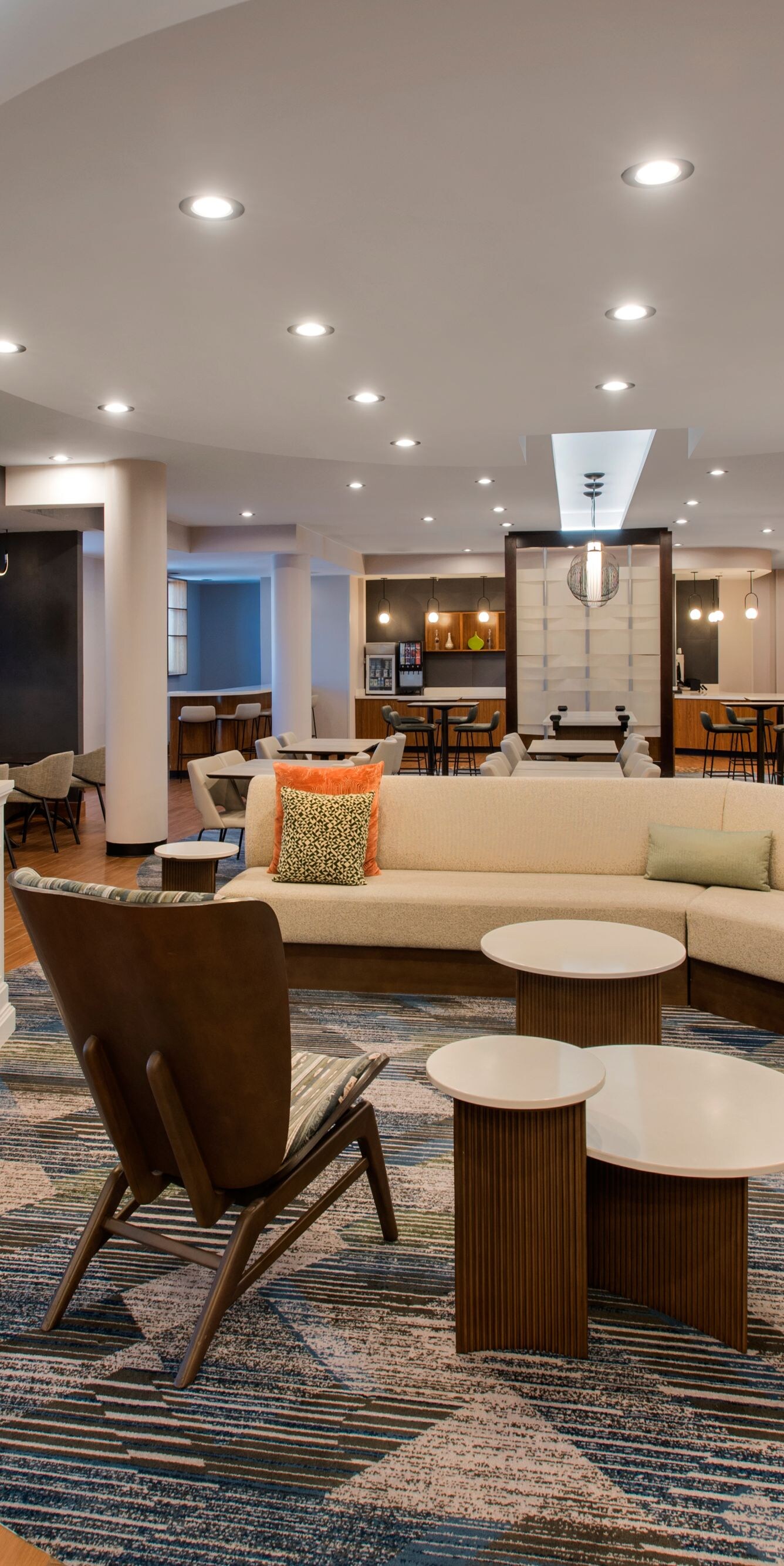 Hotel lobby with lounge seating, fireplace, tables