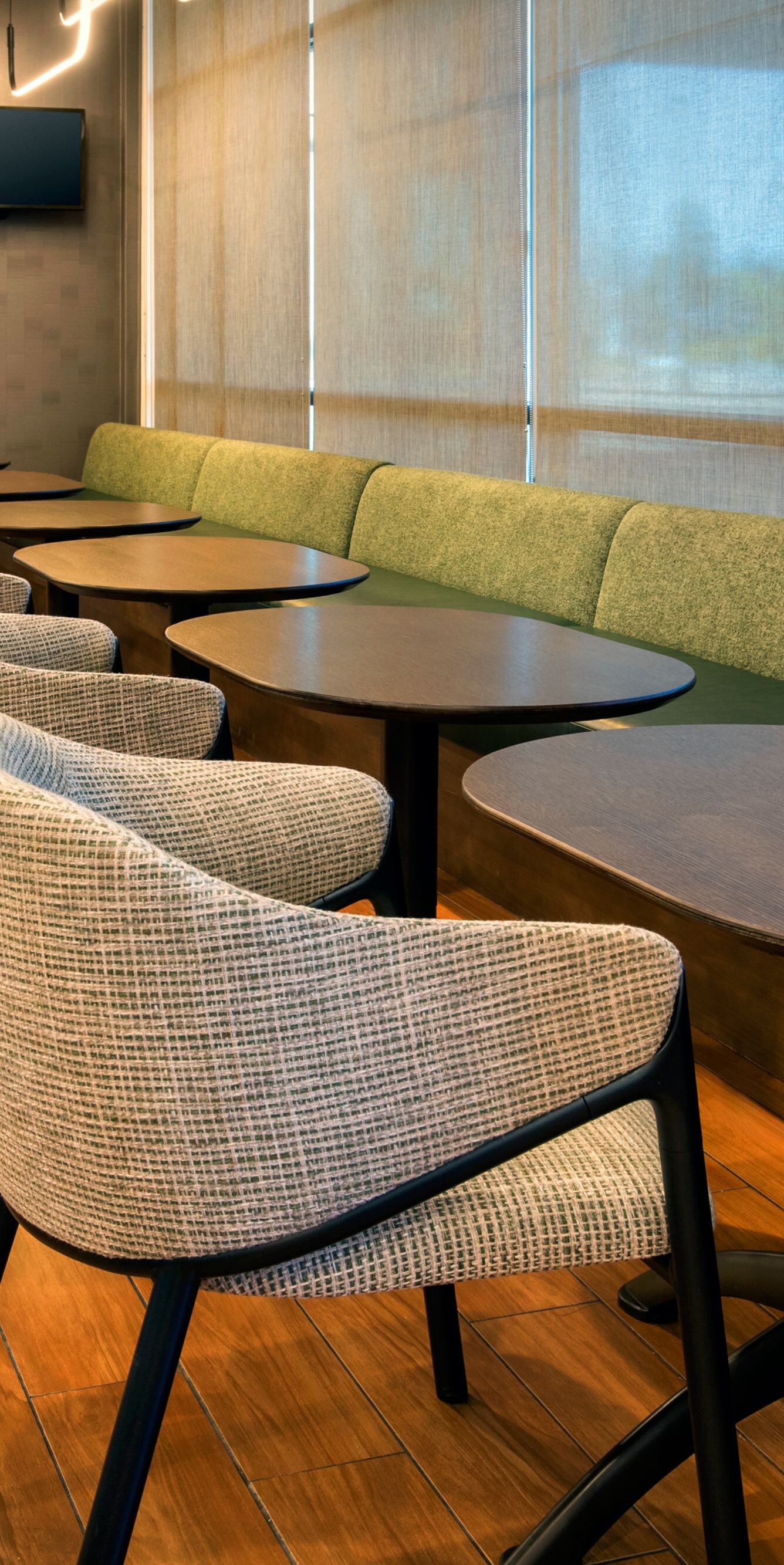 Seating area with cushioned bench seating, chairs