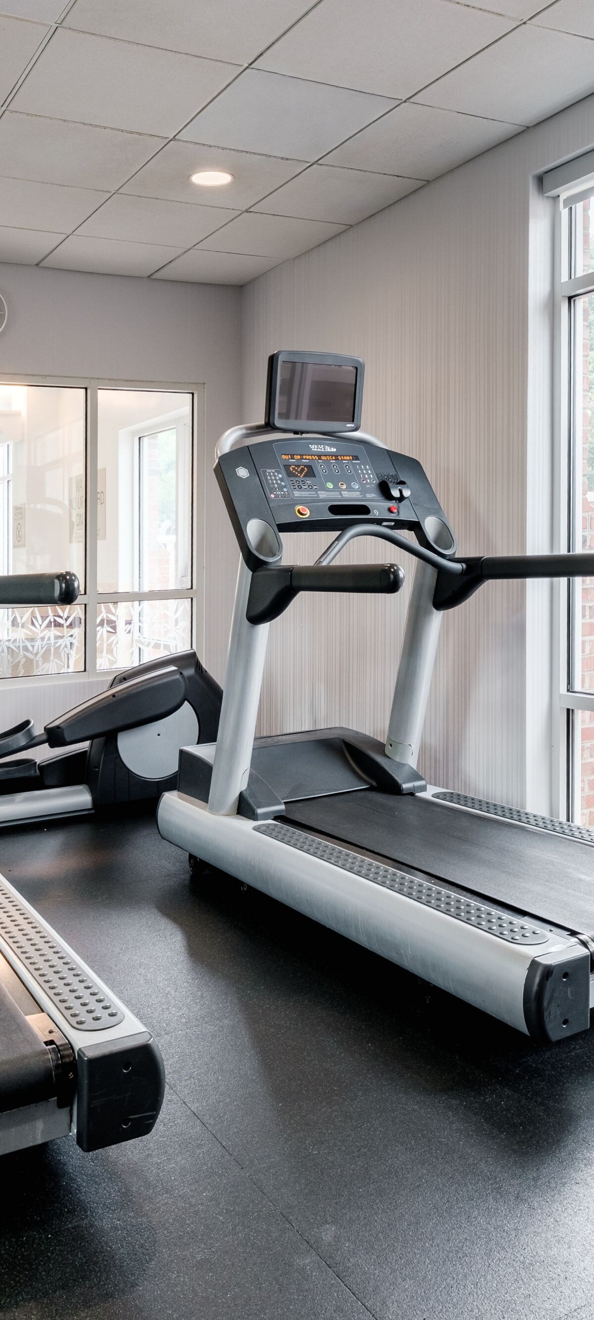 two treadmills and an elliptical machine