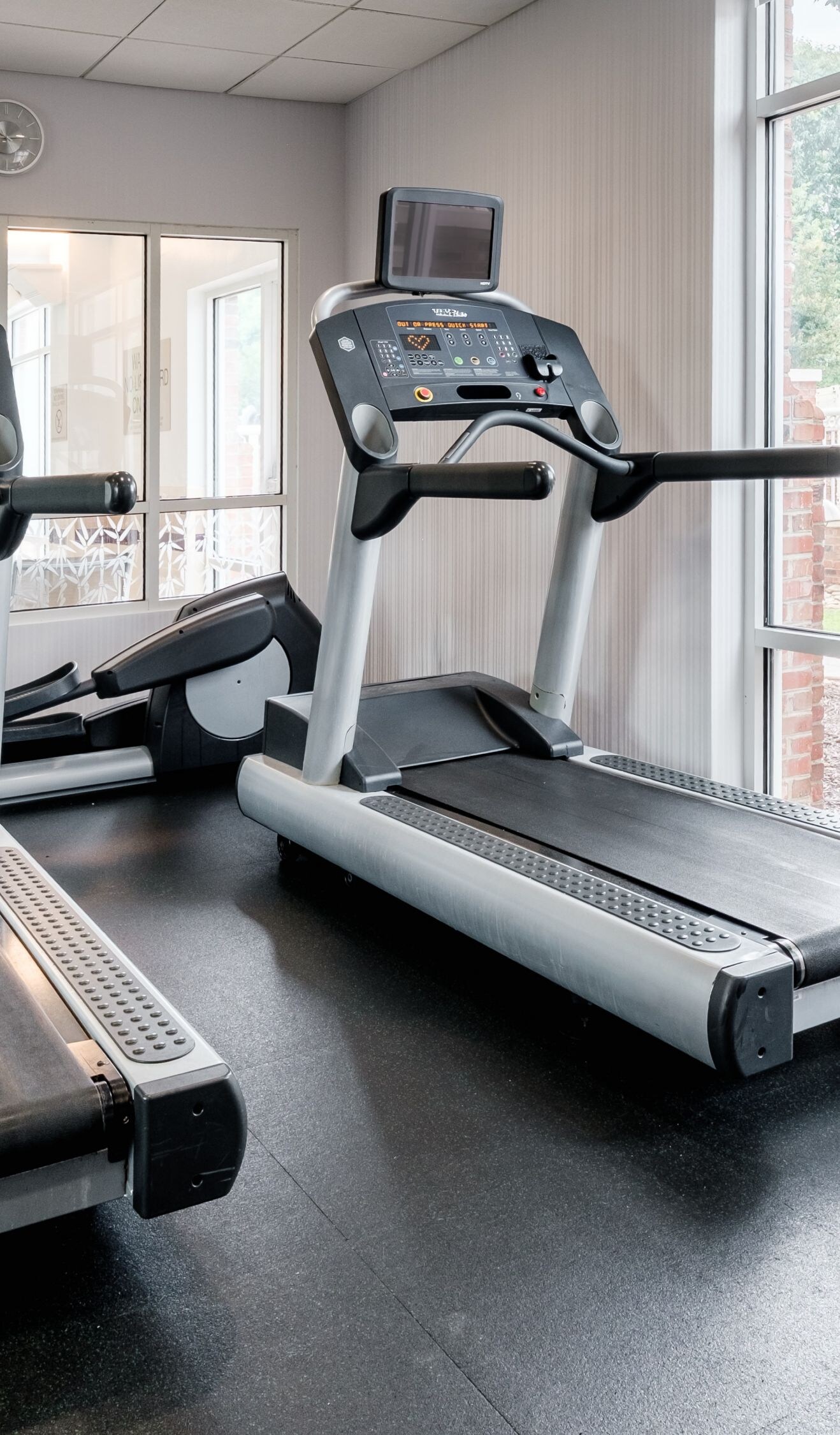 two treadmills and an elliptical machine