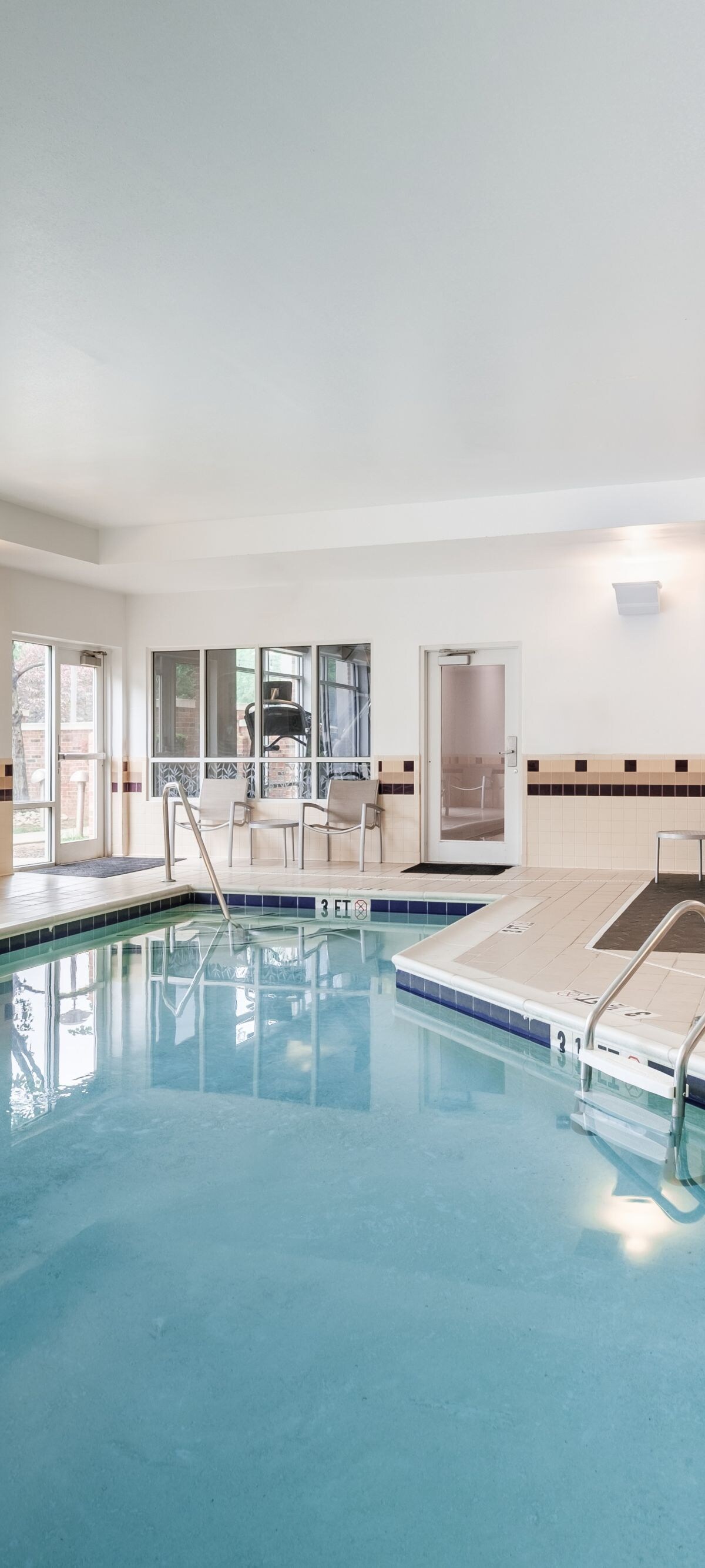 indoor pool area, chairs,and pool 