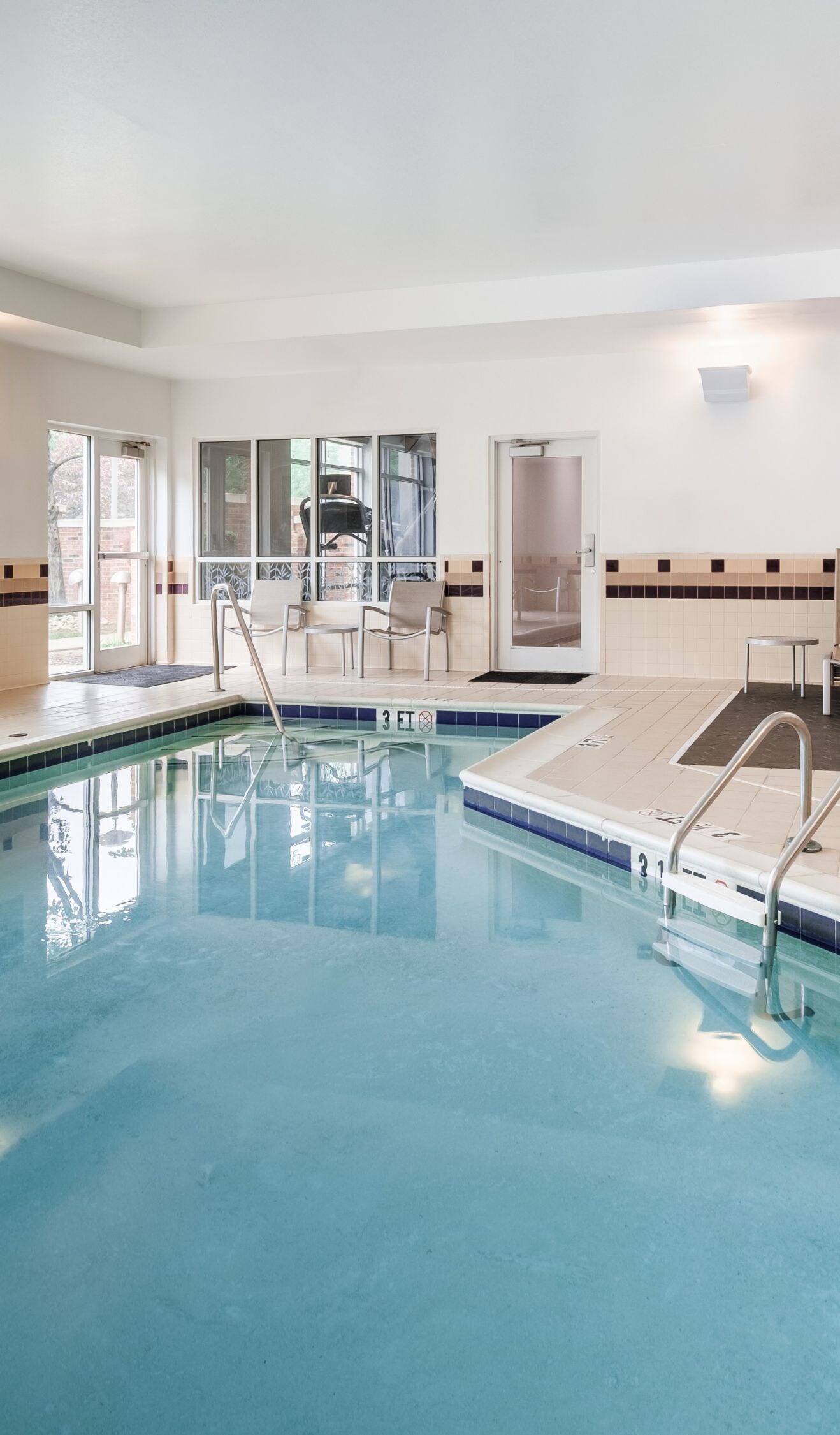 indoor pool area, chairs,and pool 