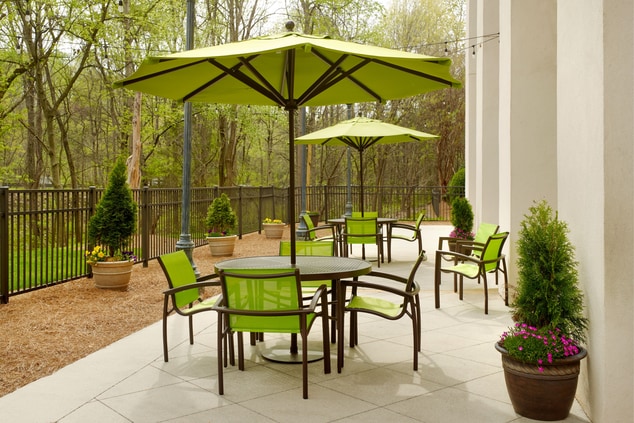 chairs, tables, umbrella, flower pots, trees