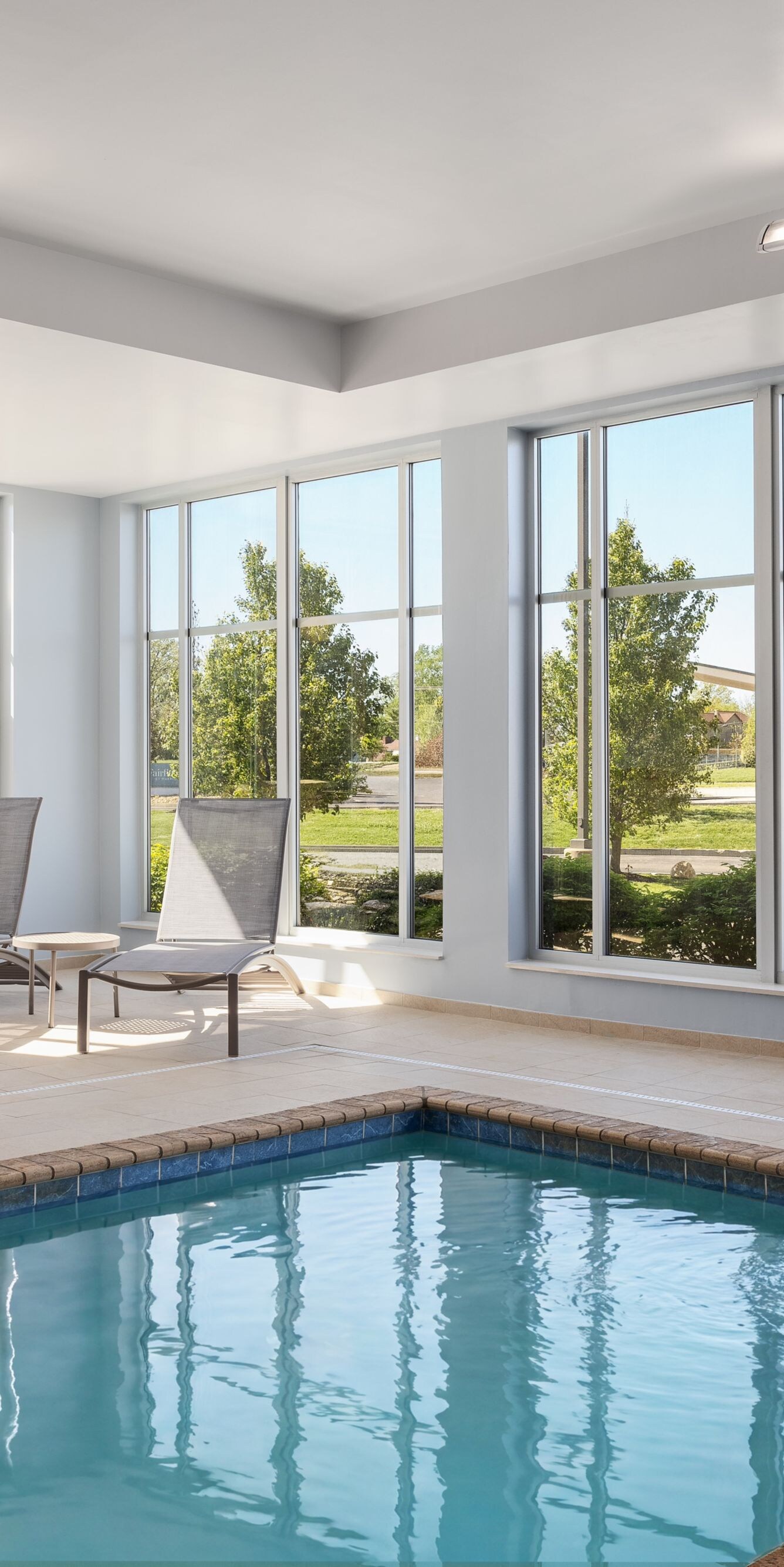 Indoor pool with lounge chairs at daytime