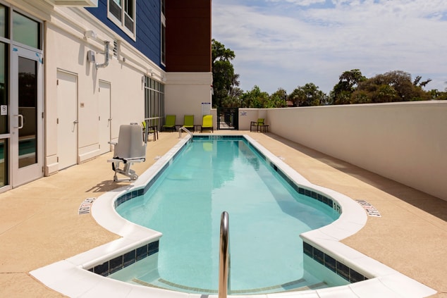 Outdoor pool with accessible pool chair.