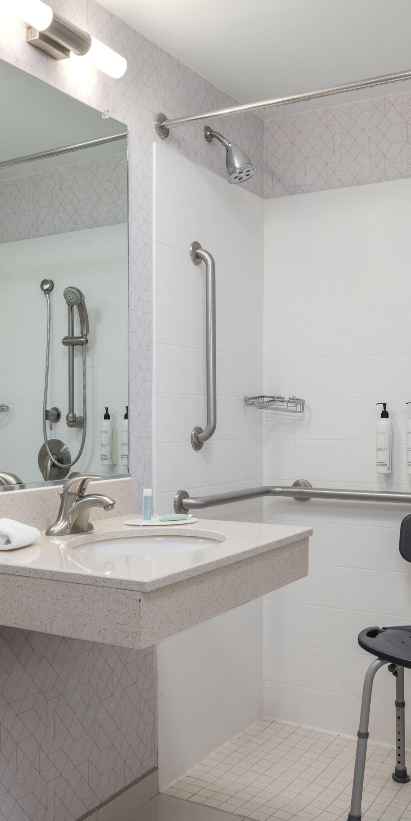 Roll-in shower with seat, grab bars, and sink