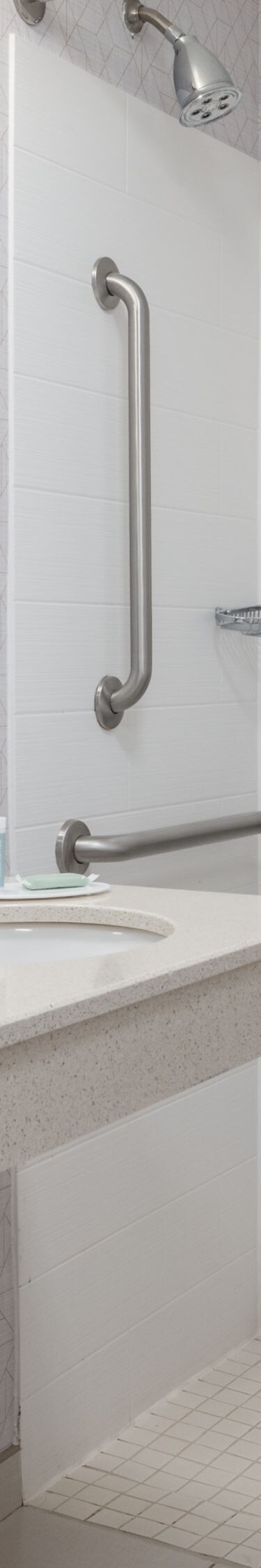 Roll-in shower with seat, grab bars, and sink