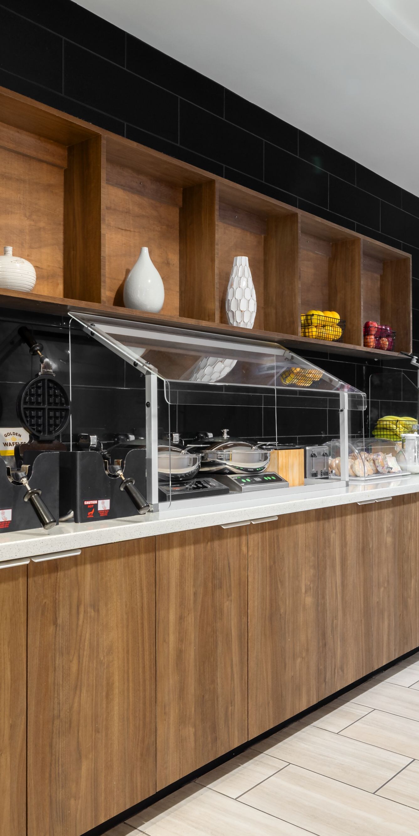 Breakfast buffet with waffle makers and beverages