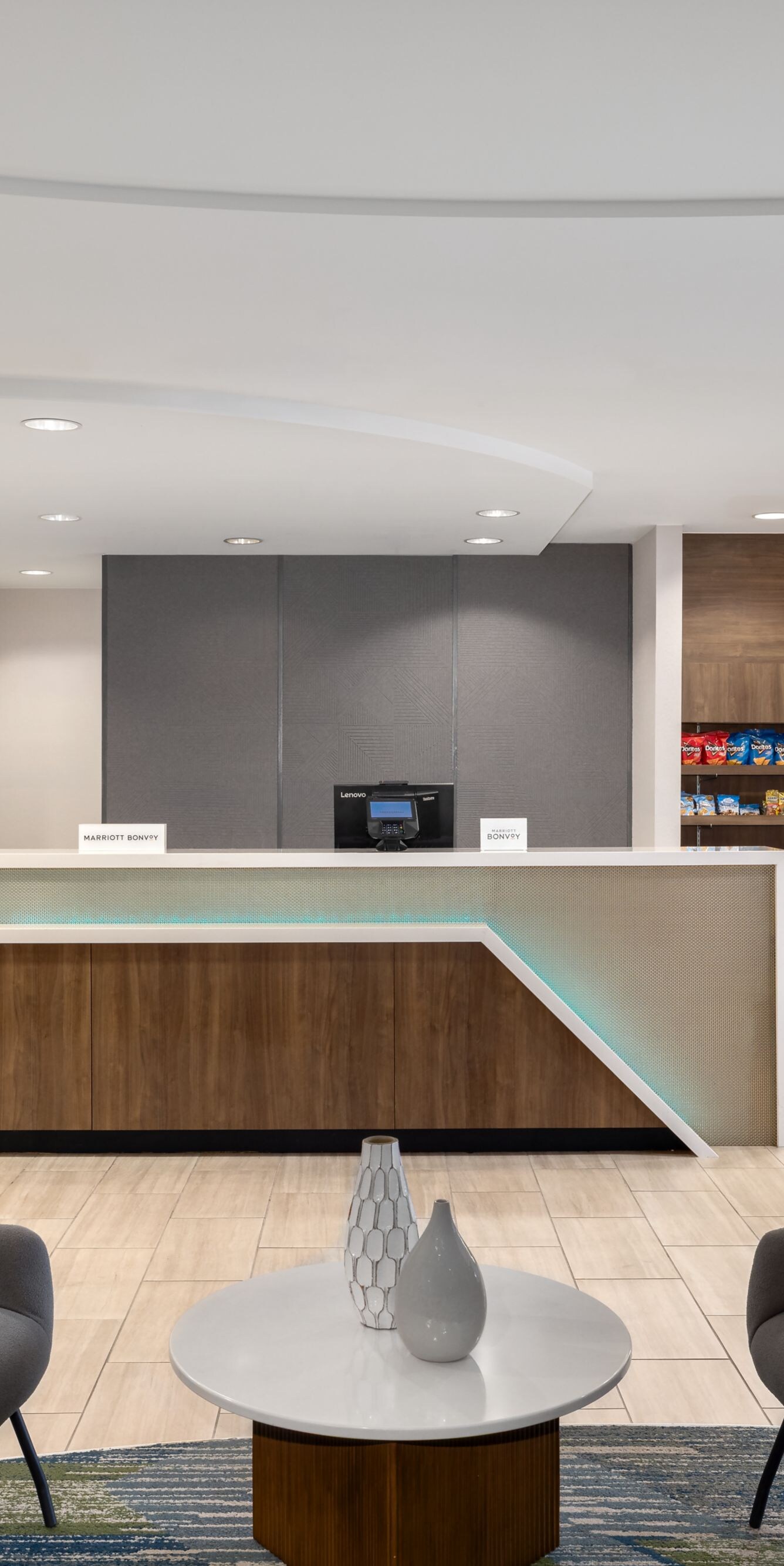Front desk with seating area and market shelves