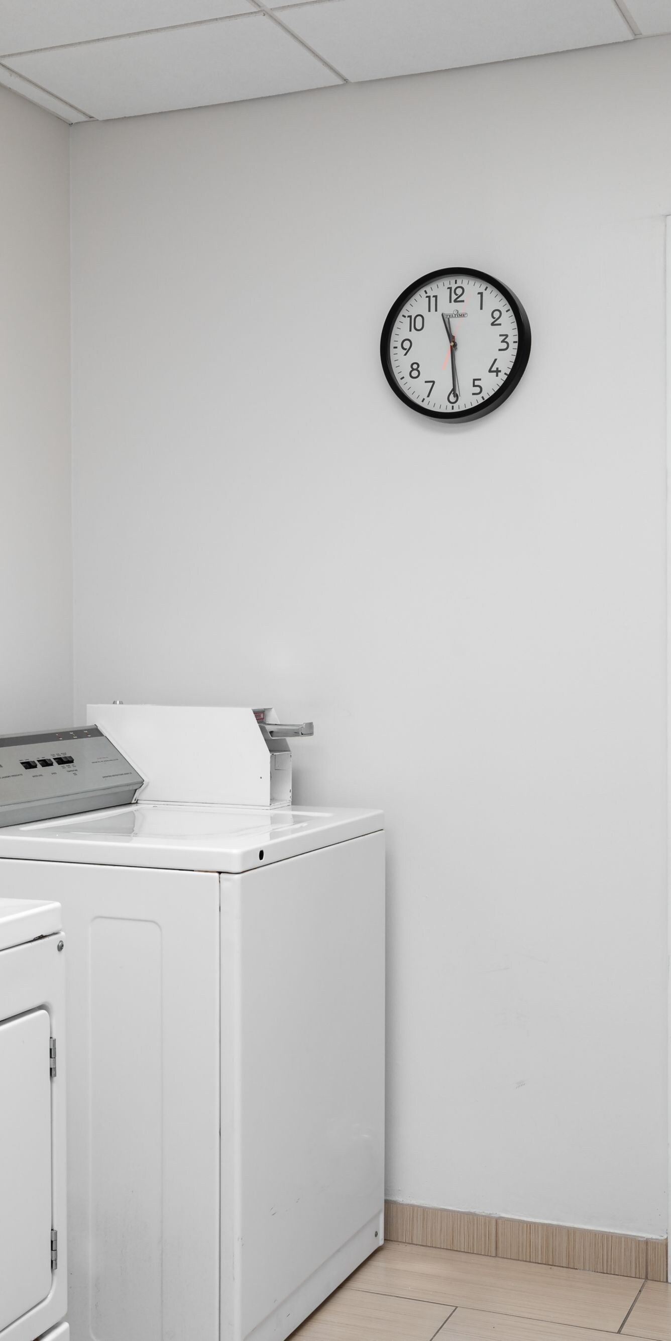 Guest laundry room with washer, dryer, and table