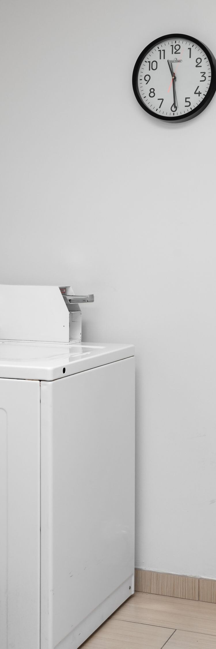 Guest laundry room with washer, dryer, and table