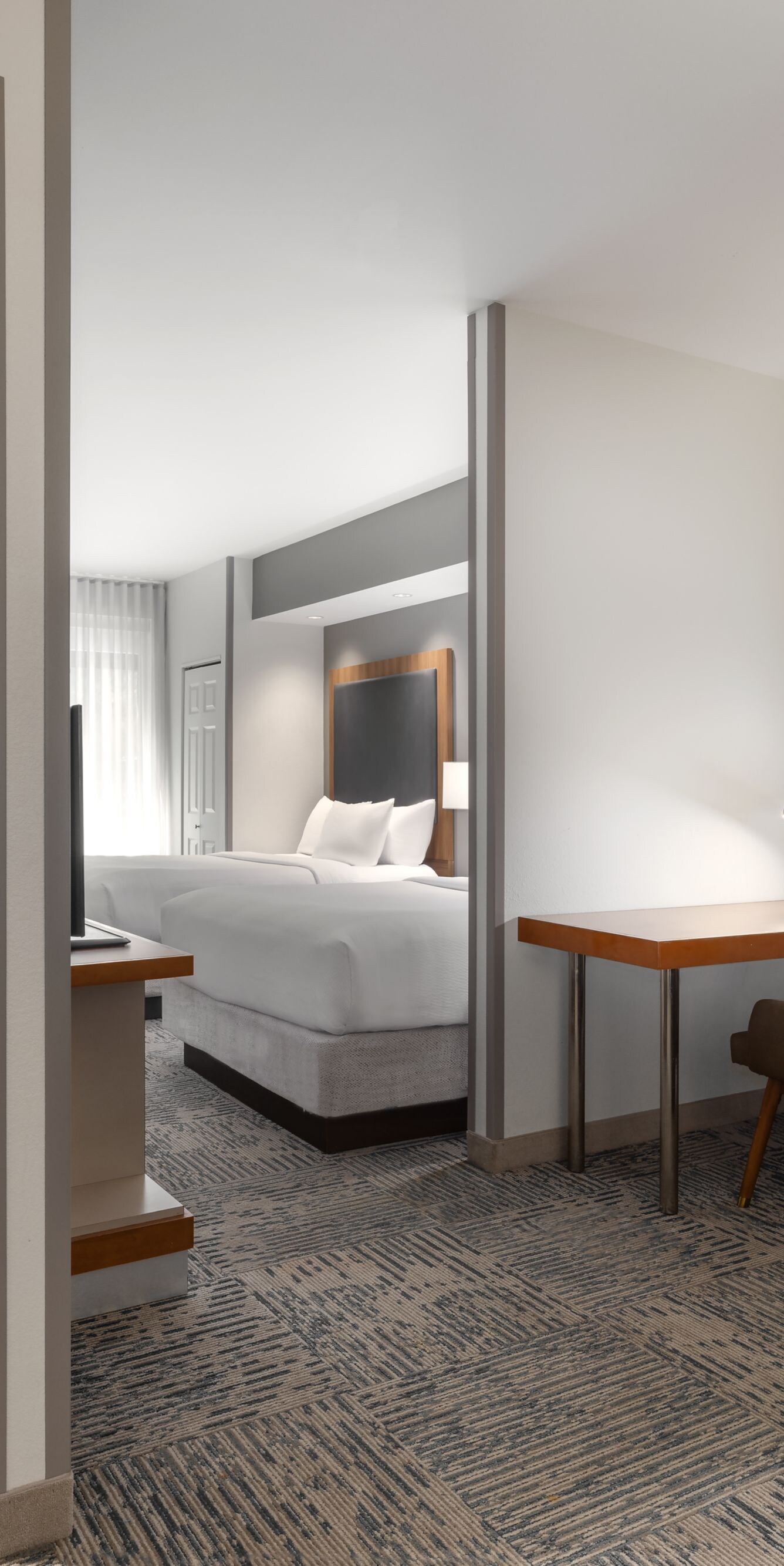Suite with kitchenette, desk, and seating area