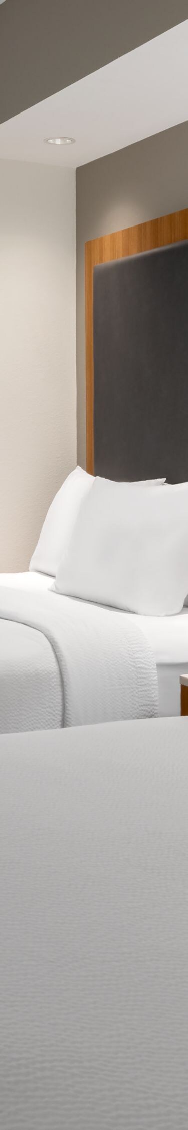 Two queen beds with window and nightstand
