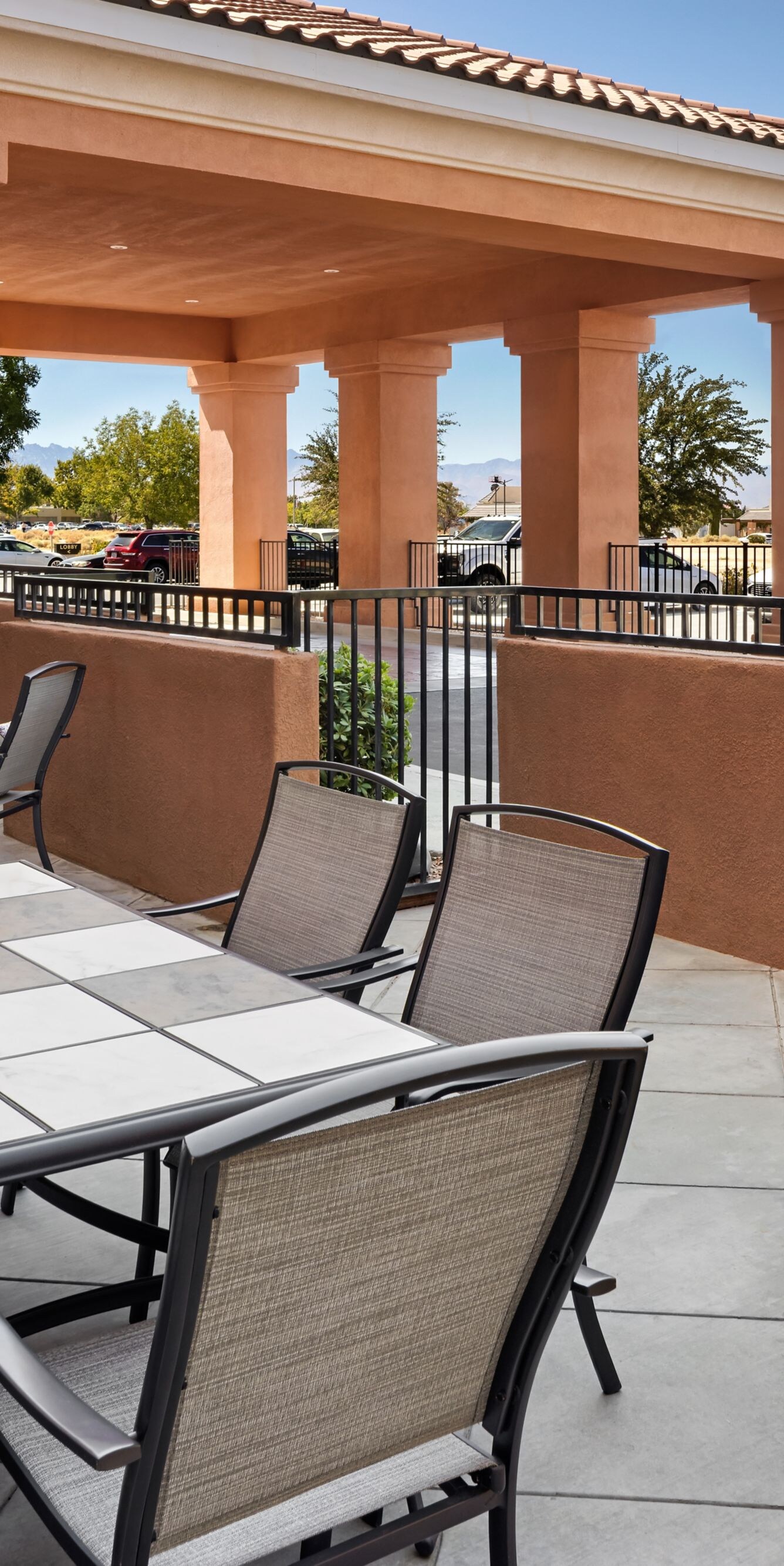 Outdoor patio with dining table and barbecue grill