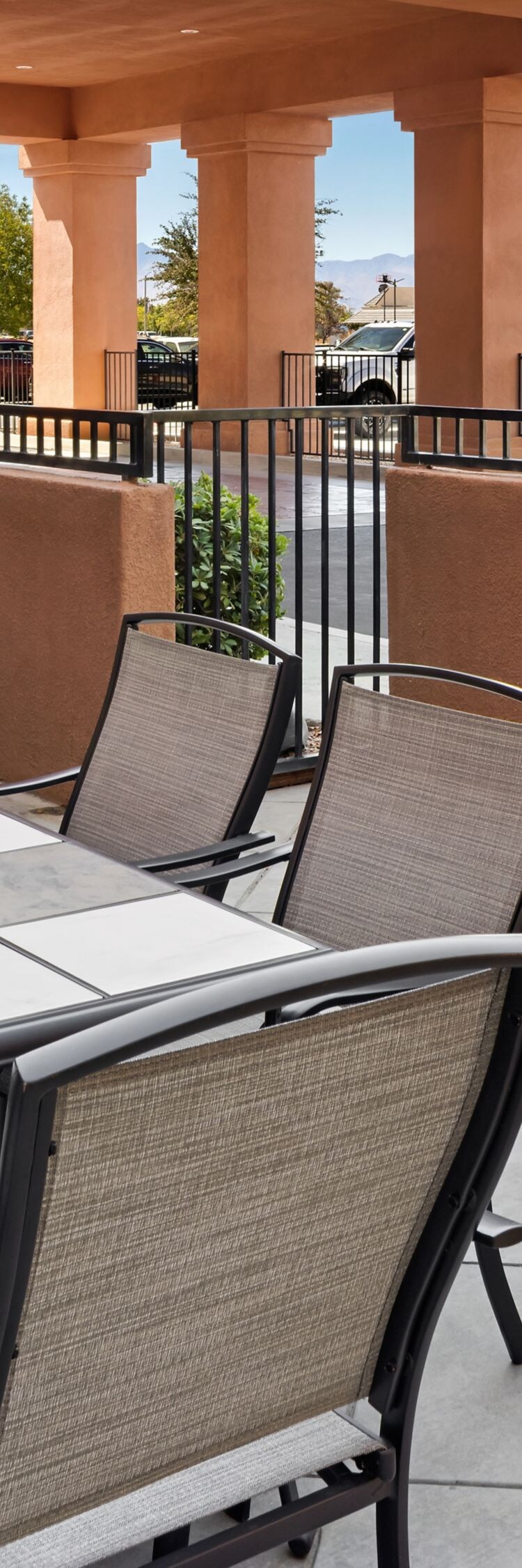 Outdoor patio with dining table and barbecue grill