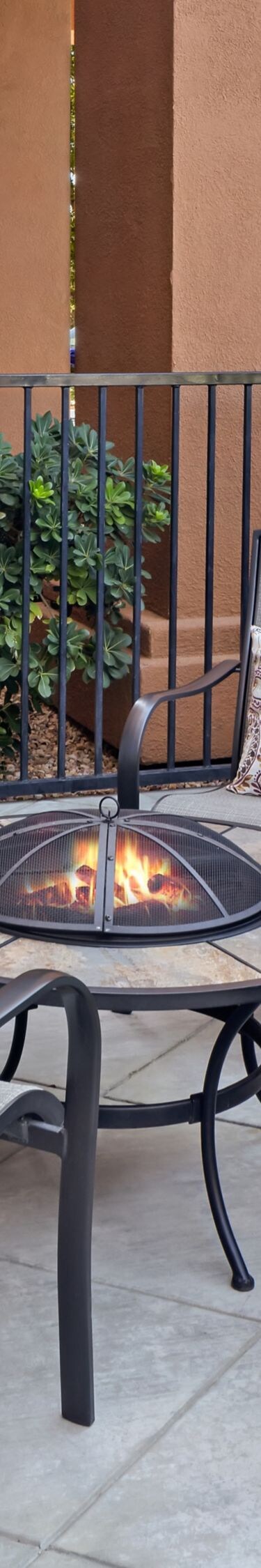 Outdoor seating area with chairs around fire pit