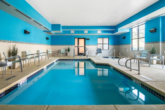 Indoor pool with chairs and tables