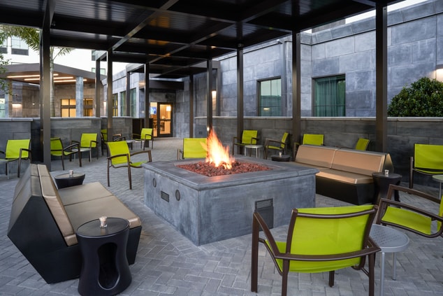Outdoor patio with fire pit and seating.