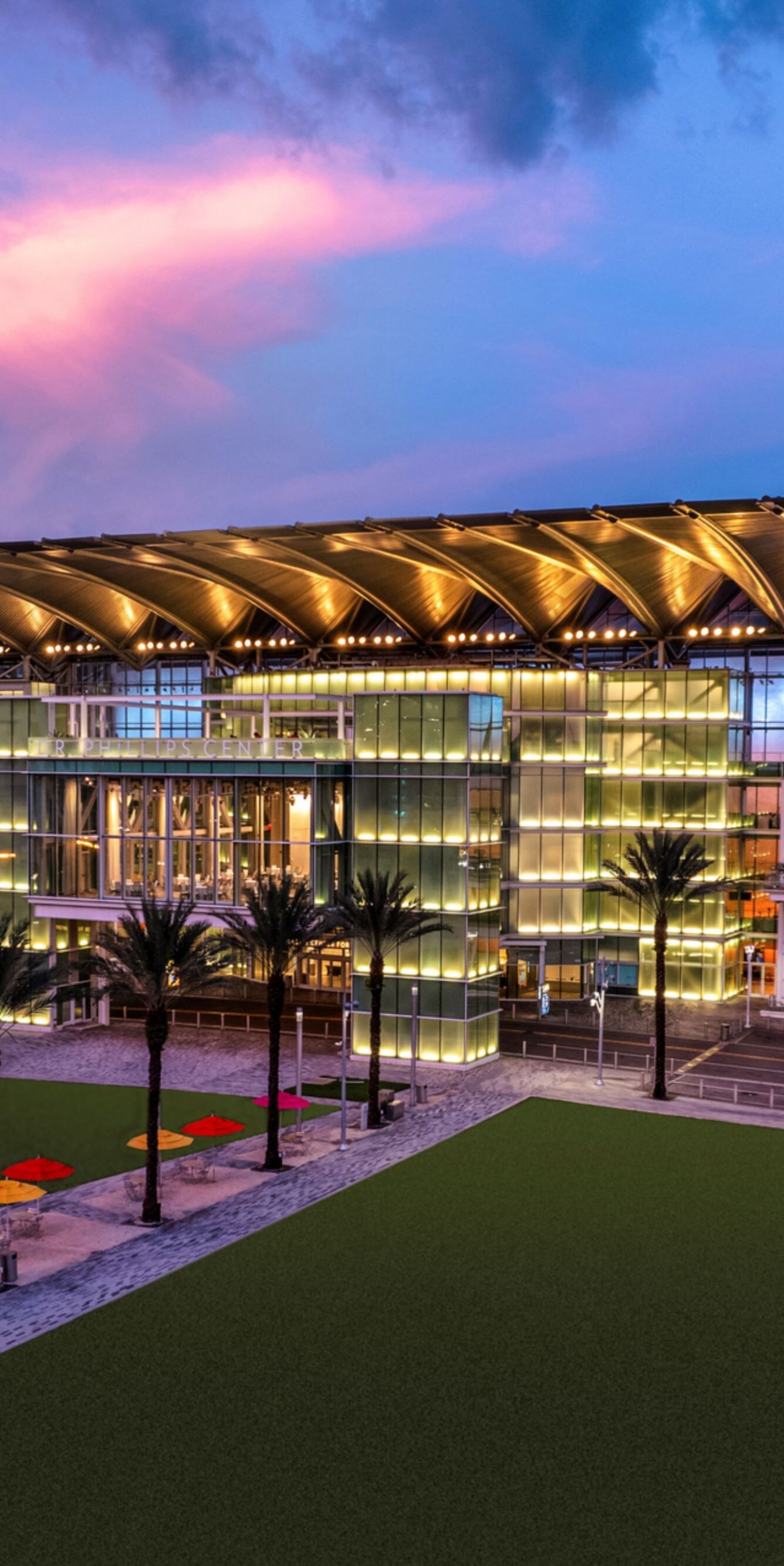 Exterior of event venue with palm trees.