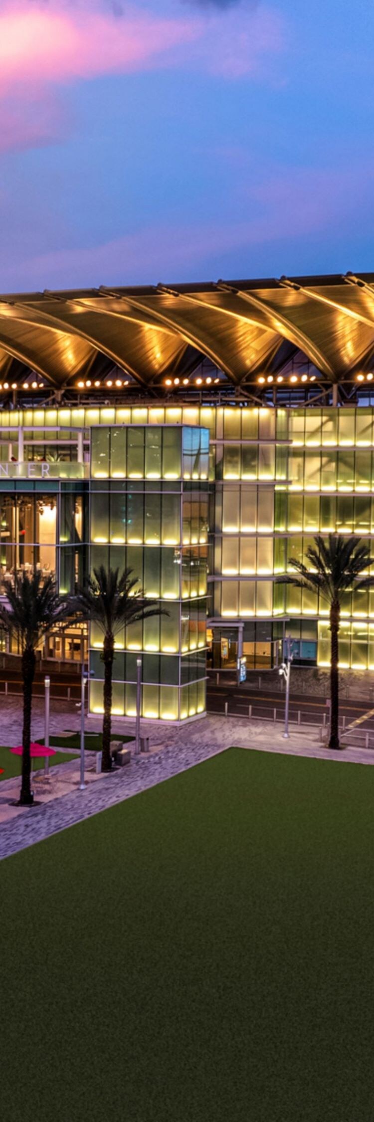 Exterior of event venue with palm trees.