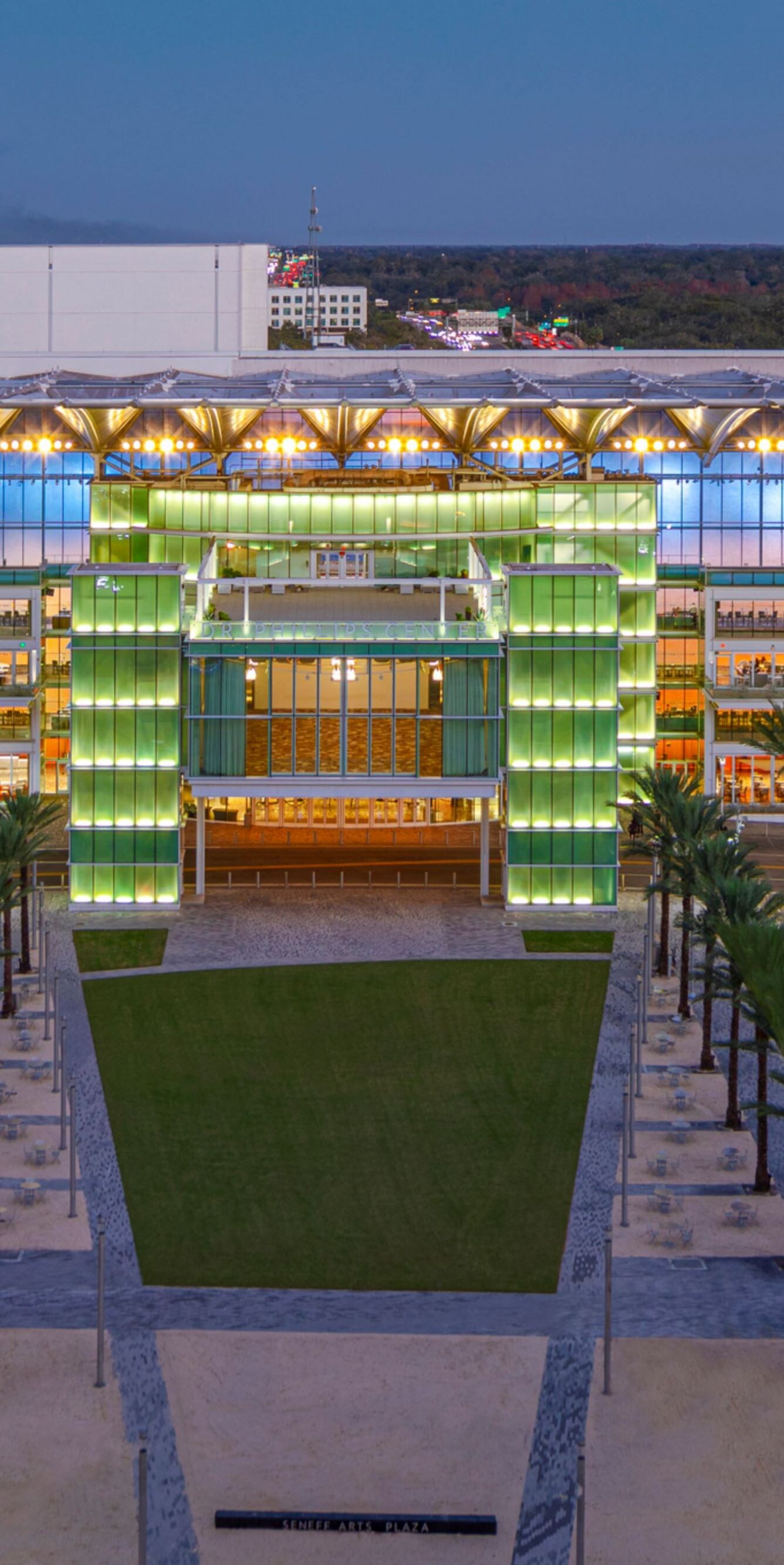Lit exterior of sports stadium at dusk