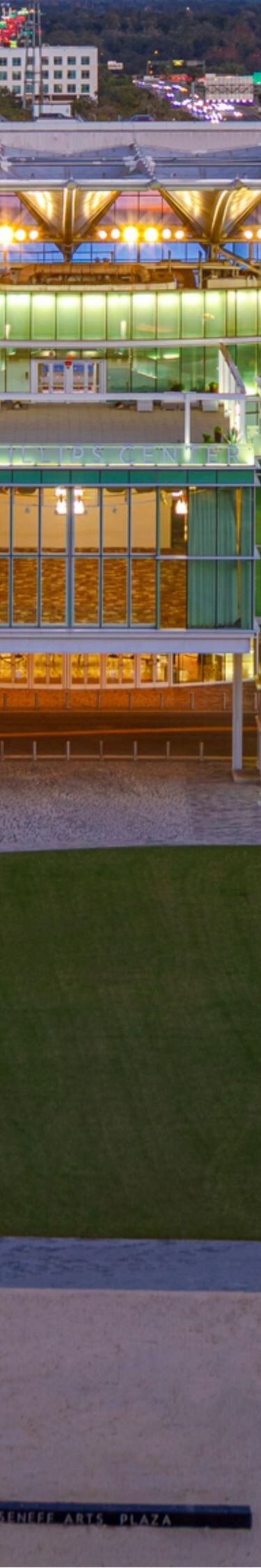 Lit exterior of sports stadium at dusk