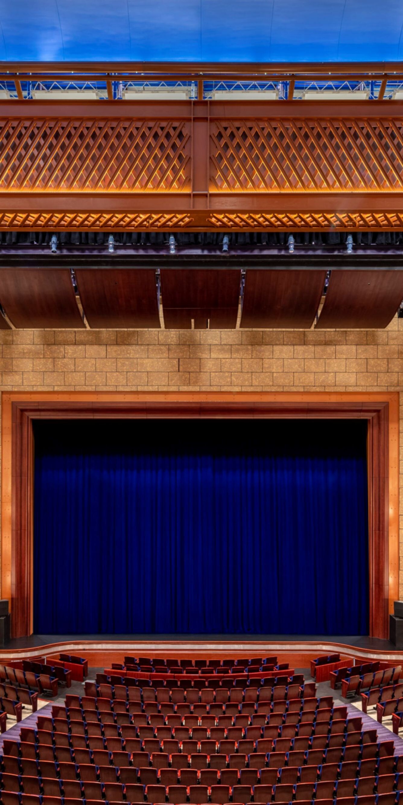 Theater with empty stage and curtain closed.