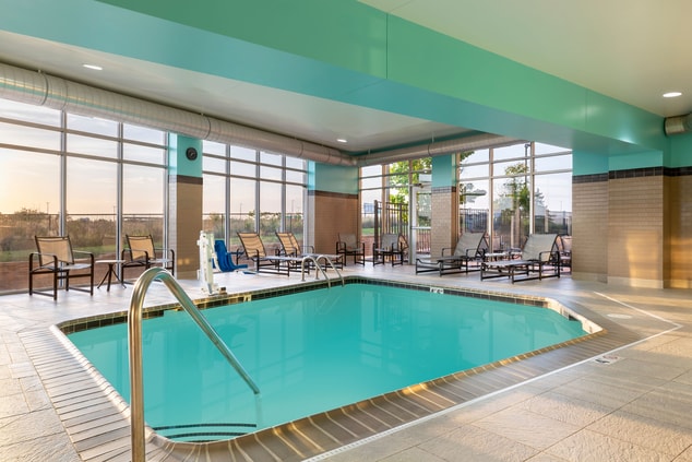 Indoor pool with chair lift and lounge chairs