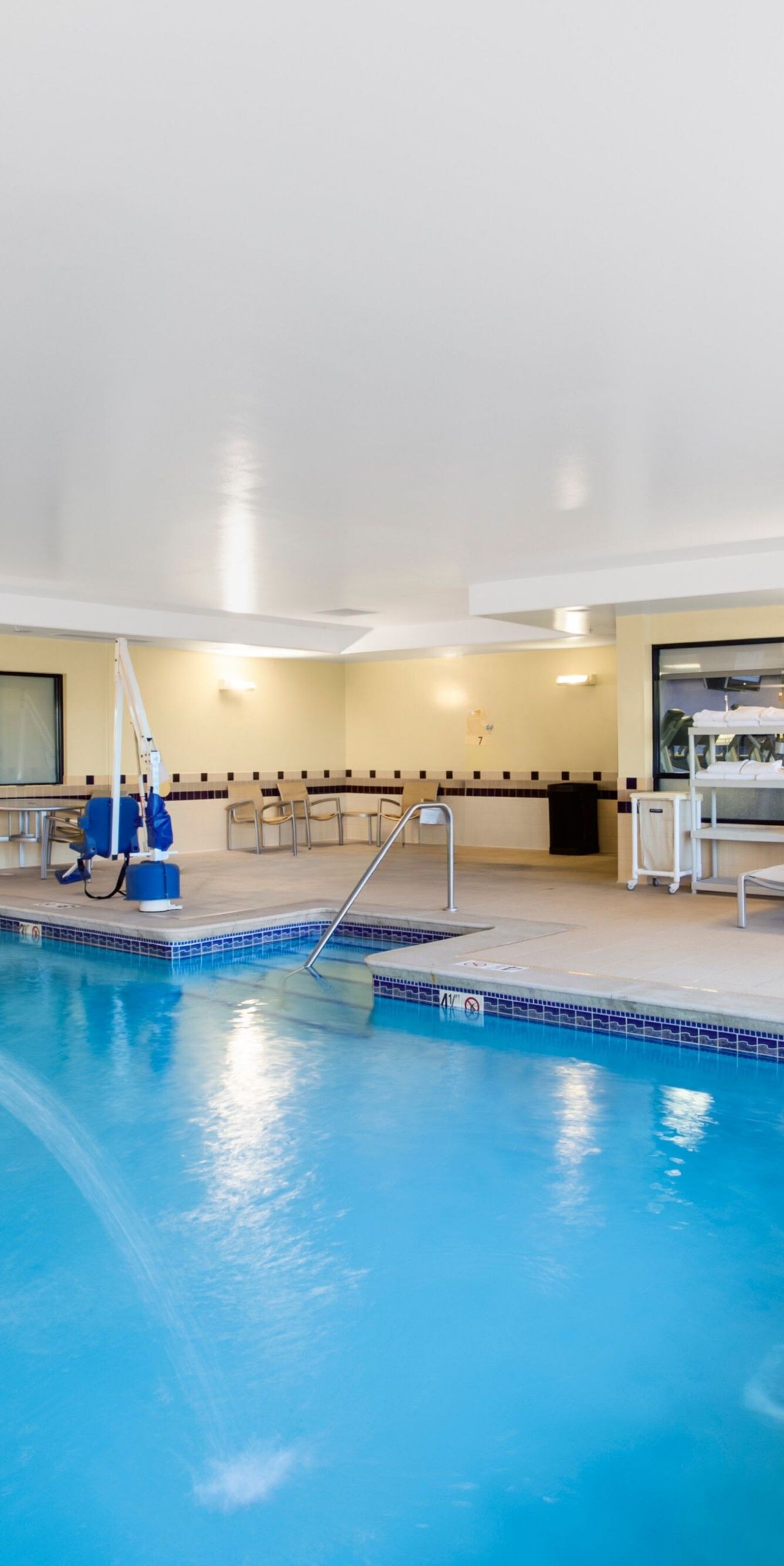 Indoor pool with lounge chairs and water features