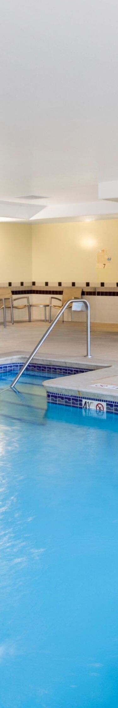 Indoor pool with lounge chairs and water features